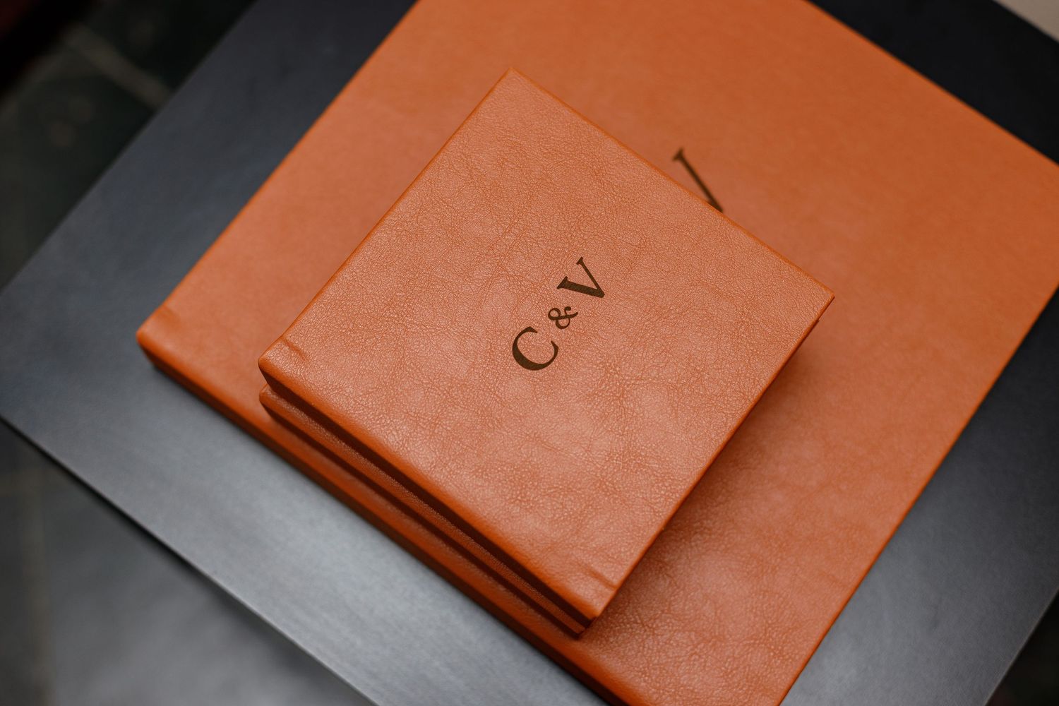 Orange leather document folders arranged in a modern minimalist style.