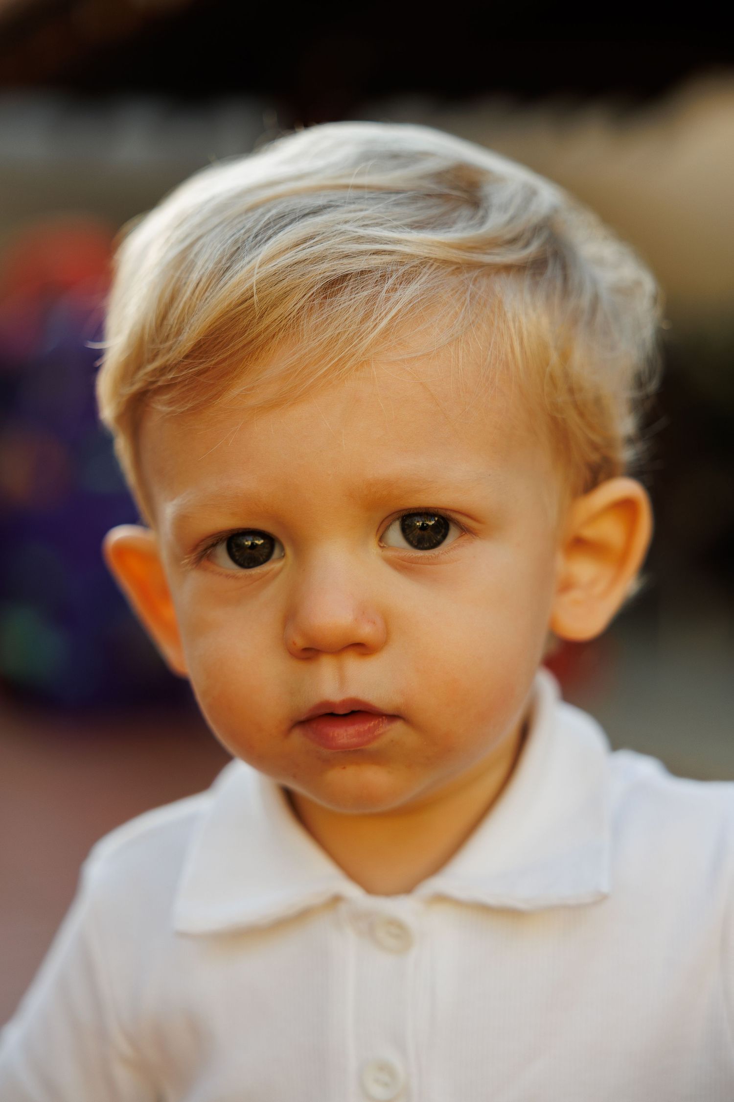 Close-up portrait series showing different angles of a child in a white polo shirt.