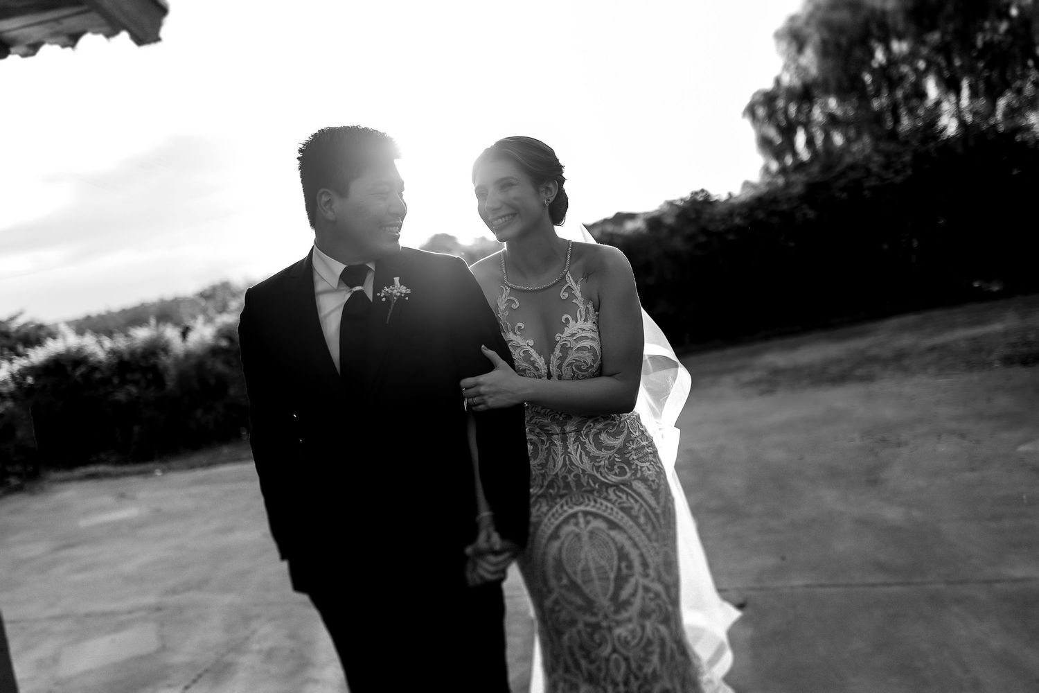 A romantic black and white wedding photo sequence showing a couple walking together on a hillside.
