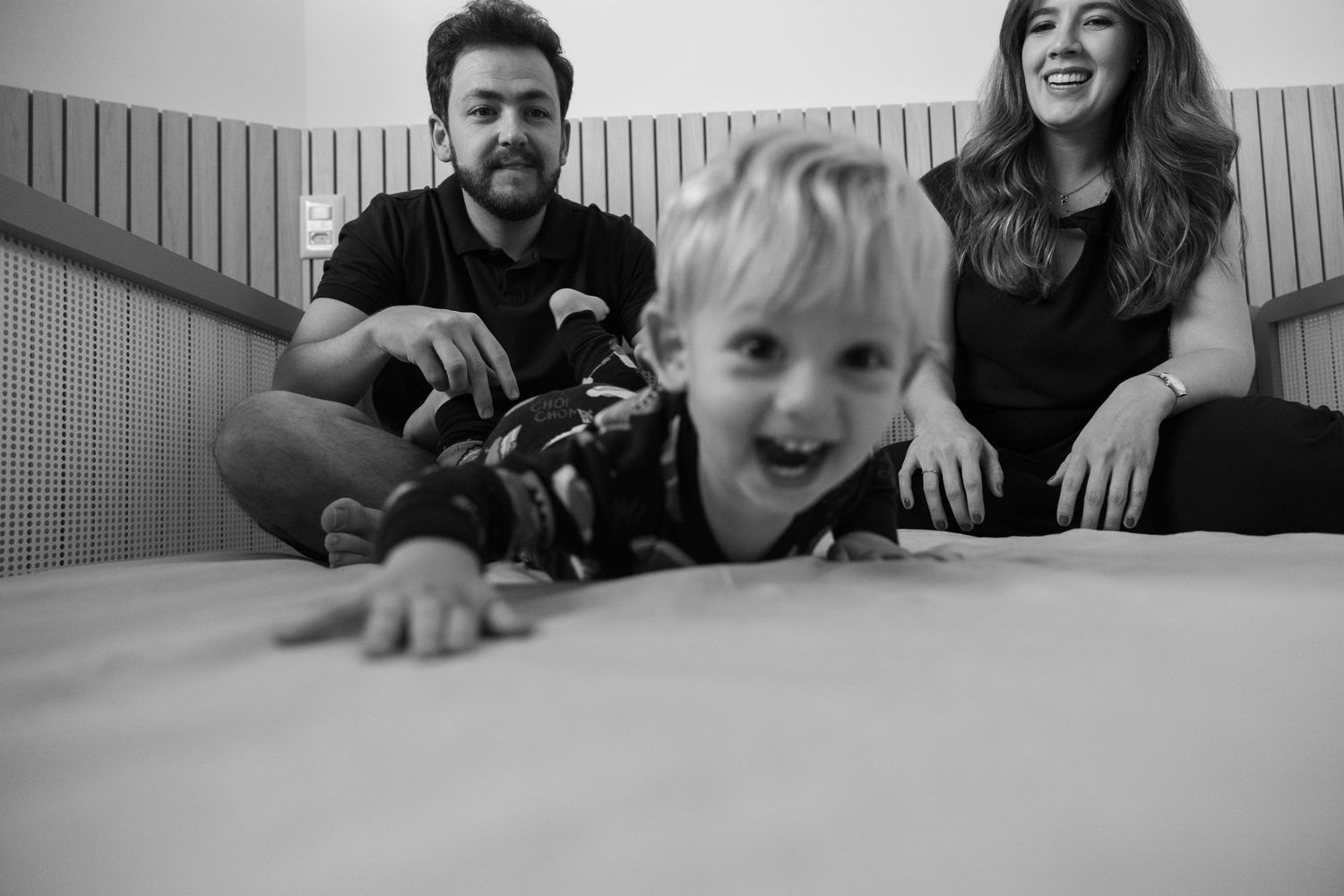 Friends having fun and laughing while lounging together indoors.