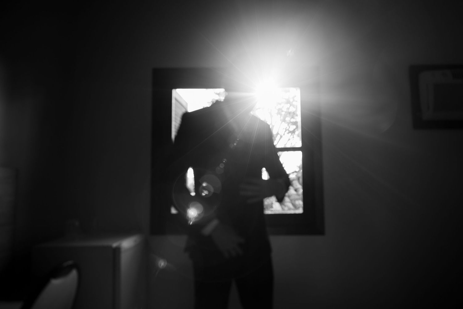 Silhouettes move through a dimly lit hallway with dramatic lighting effects.