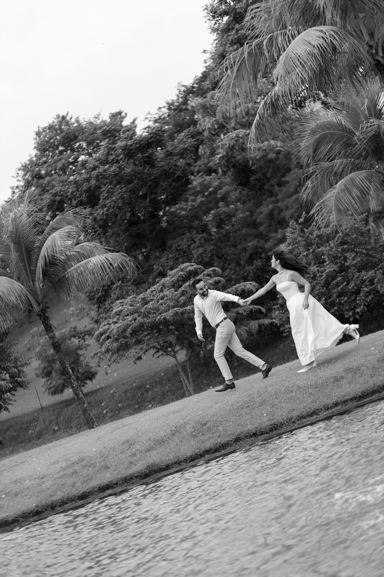 Black and white sequence of playful moments on a grassy hill.