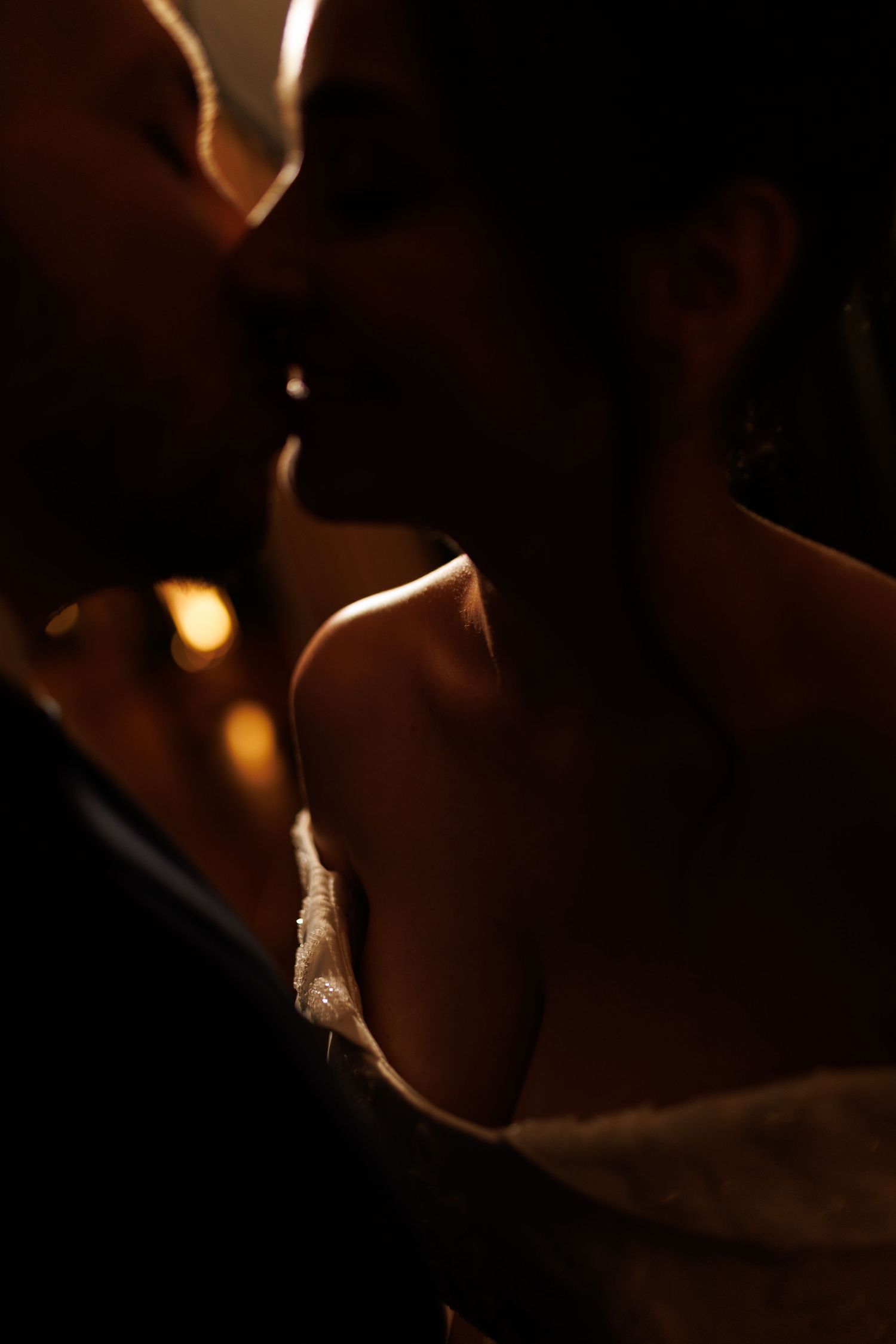Romantic silhouette of a couple in warm dramatic lighting.