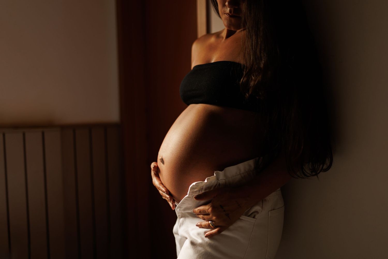 Artistic silhouette portraits in warm lighting showing a figure in various poses.