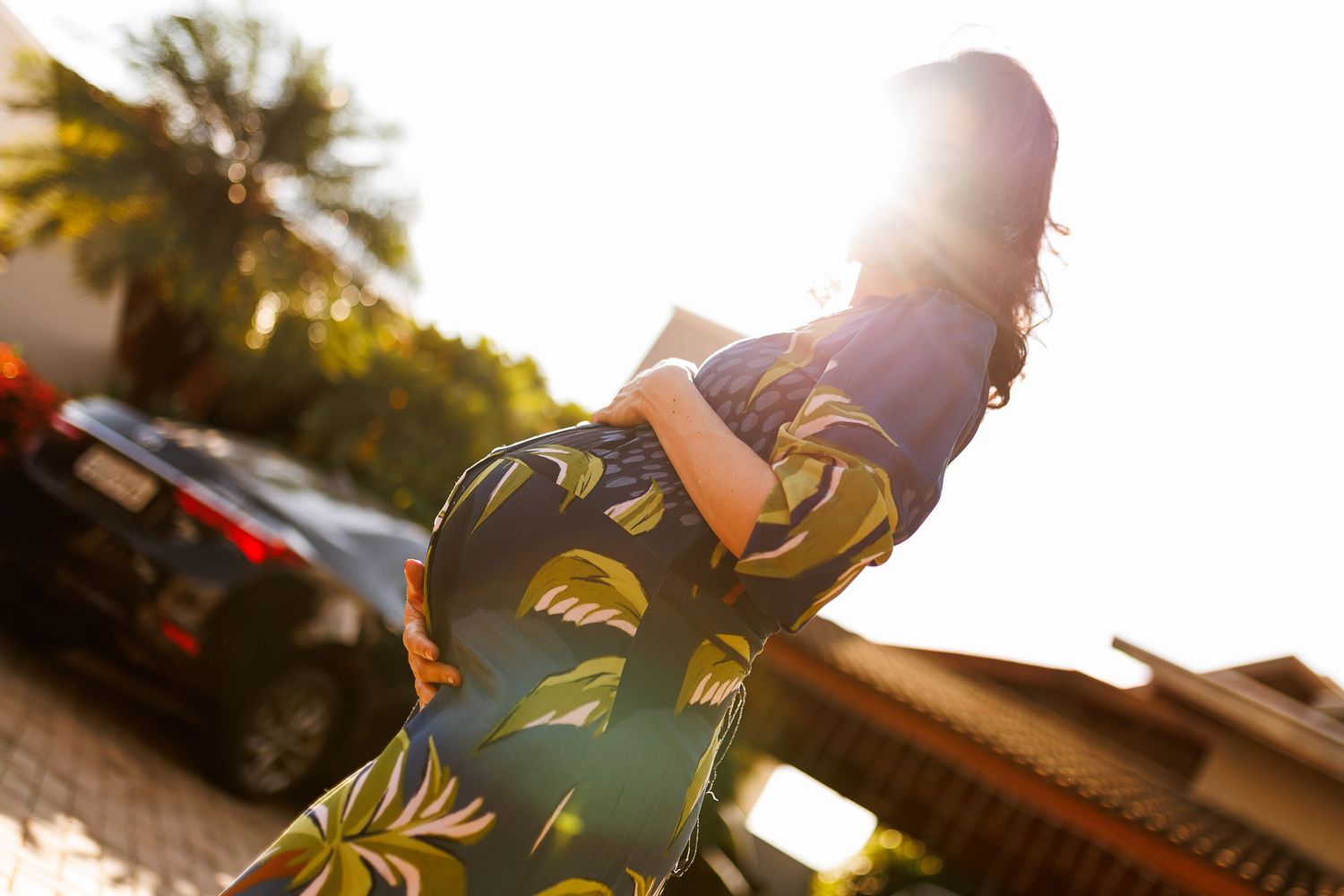 Sunlit portrait session with tropical palm trees creating a golden hour atmosphere.