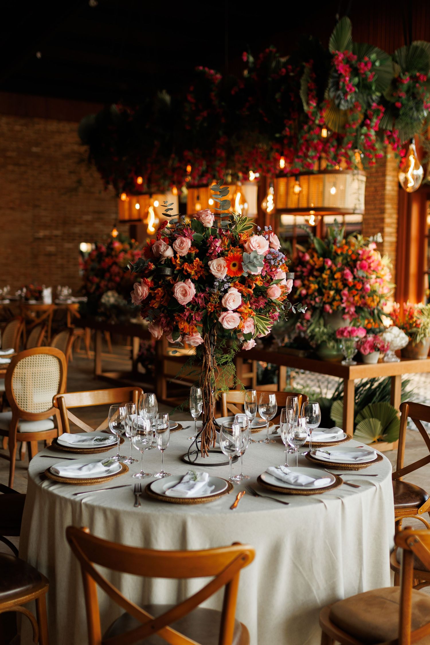 Elegant wedding reception tables decorated with floral centerpieces and candlelight.