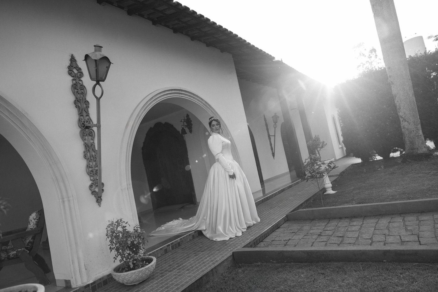 Black and white architectural wedding photos with dramatic shadows and arched walkways.