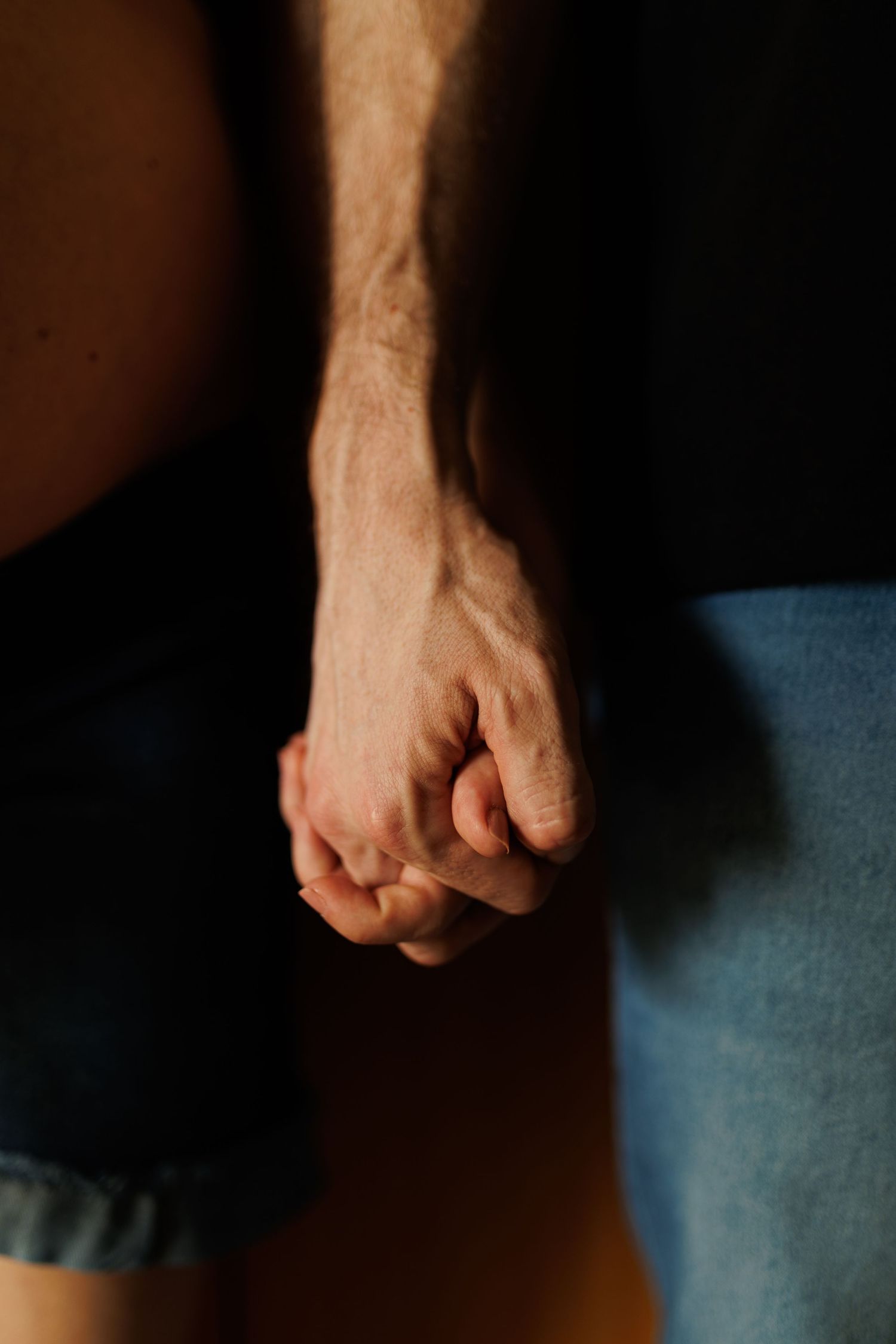 Close-up sequence of a clenched fist against dark background showing subtle movement.