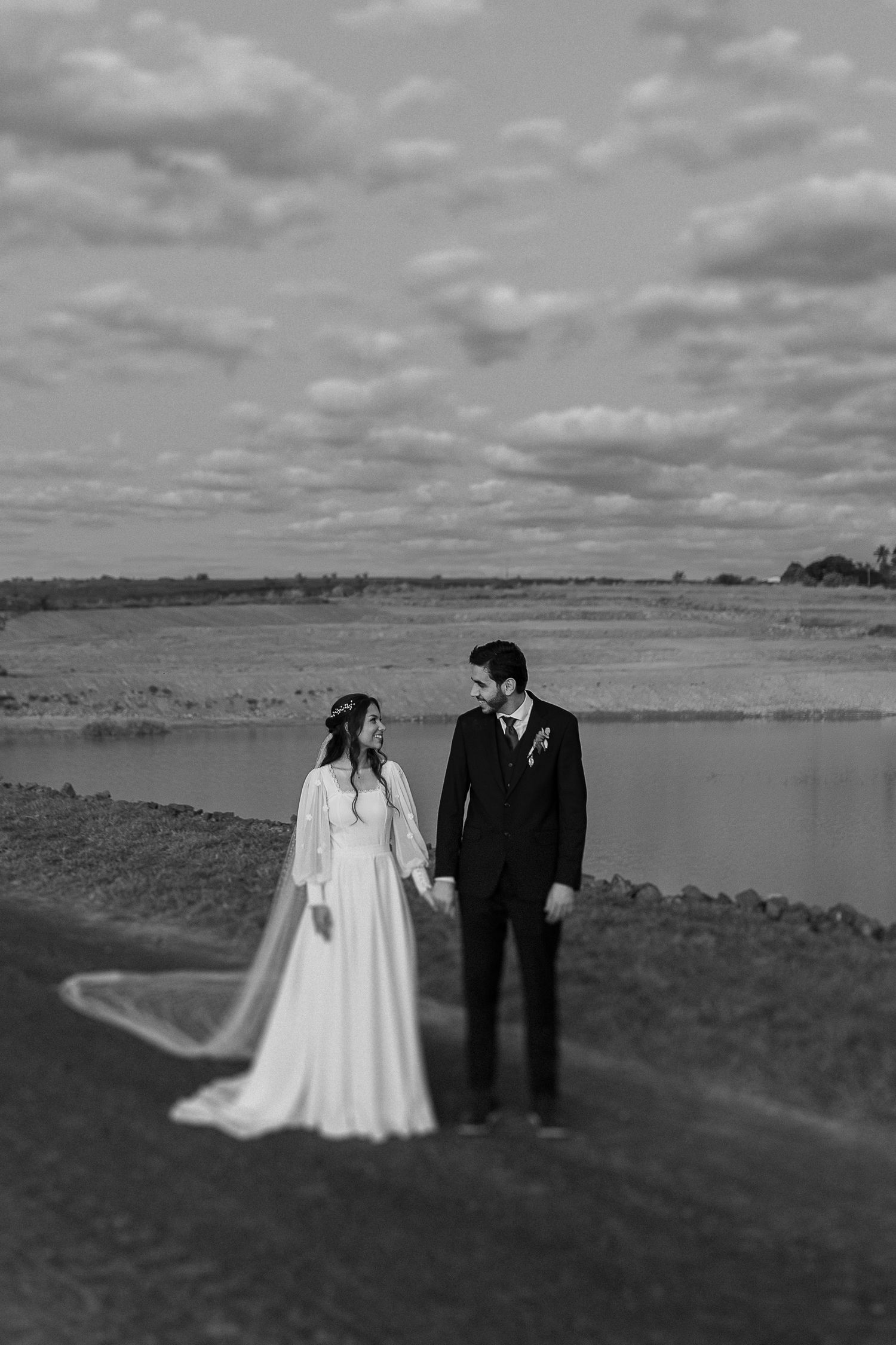 Black and white landscape photos of newlyweds standing together against a scenic backdrop.