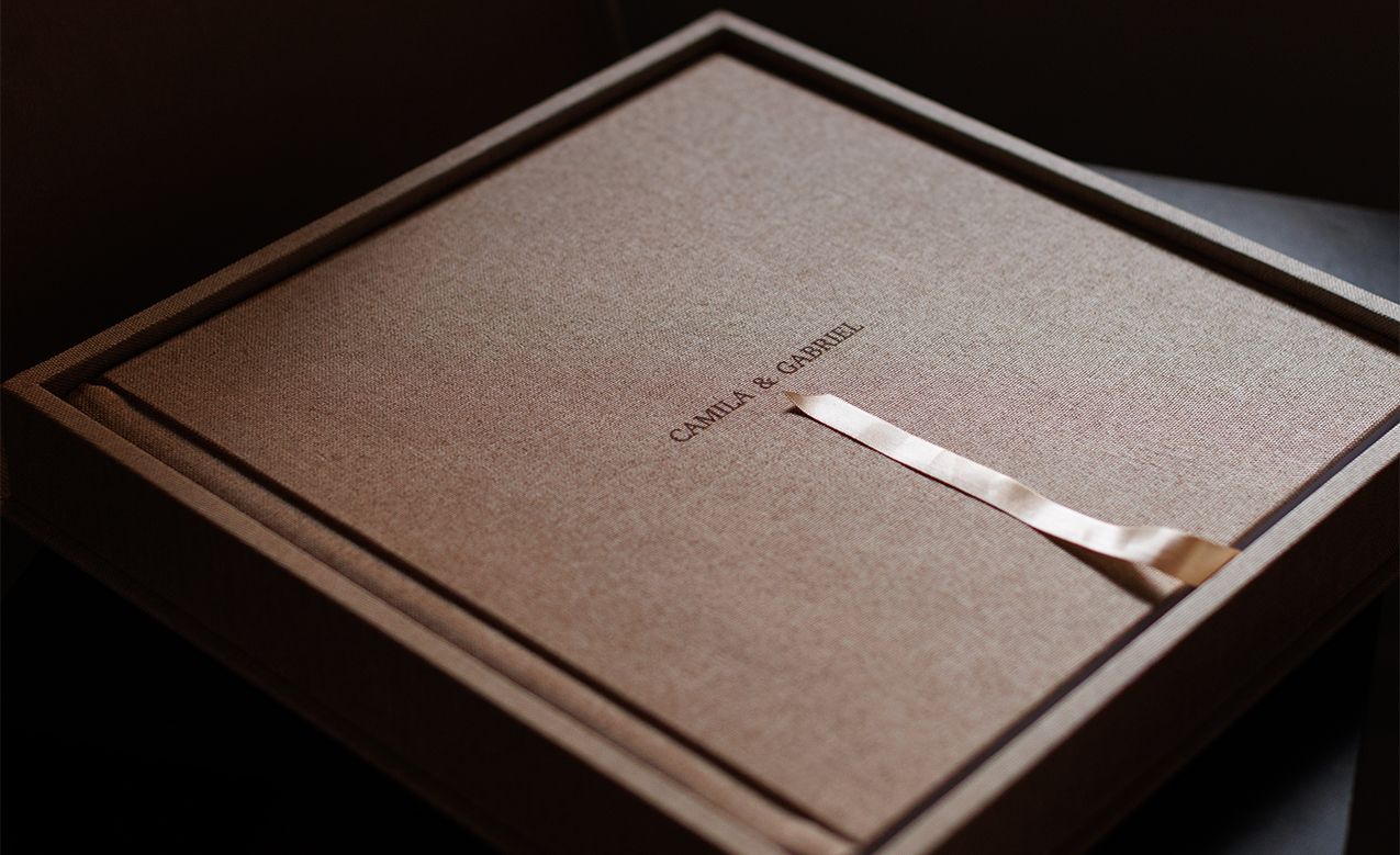 Paper documents with elegant typography arranged on a dark surface.