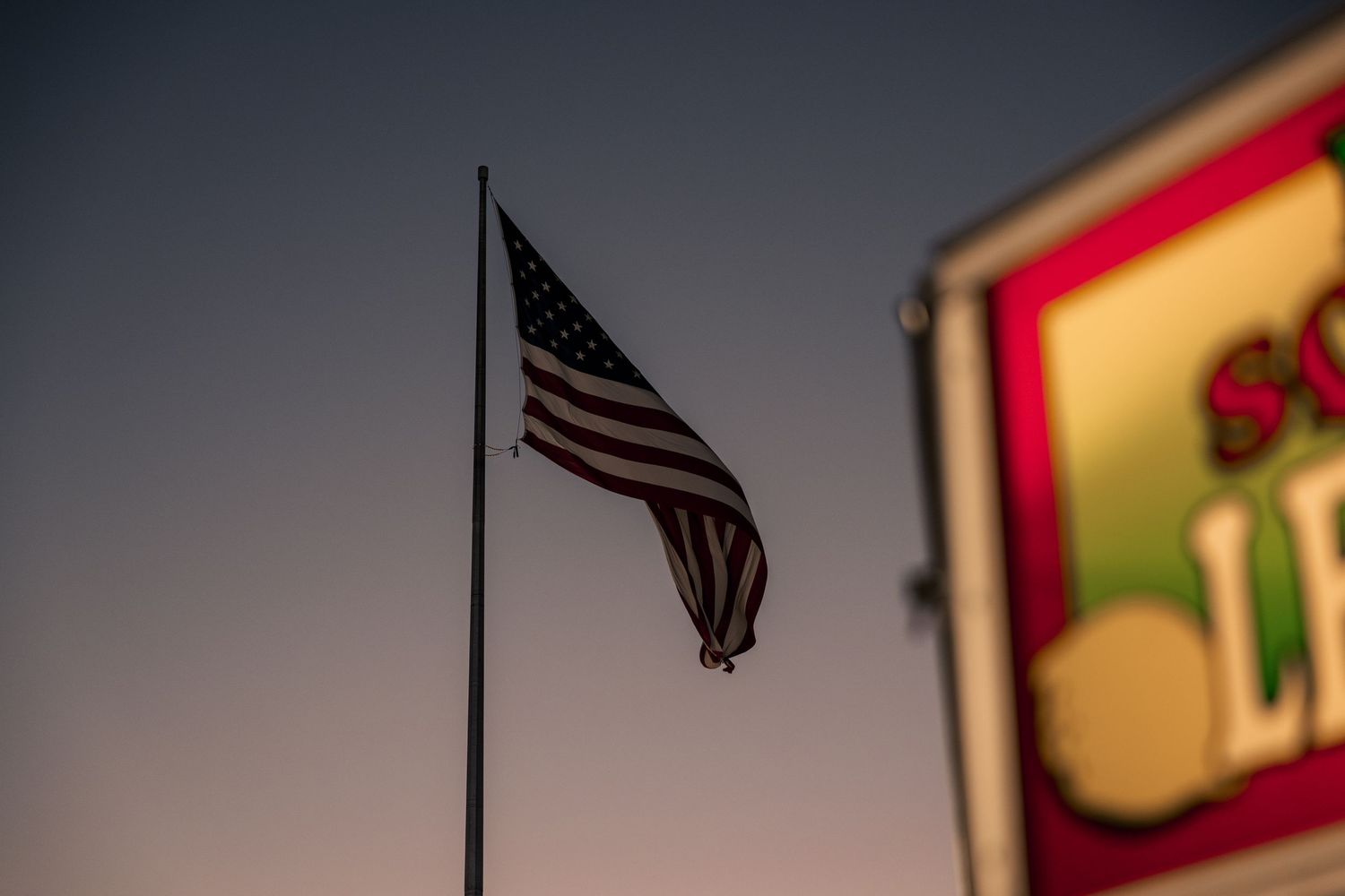Warm mood sunset landscape photo of American flag at the Tulsa state fair.
