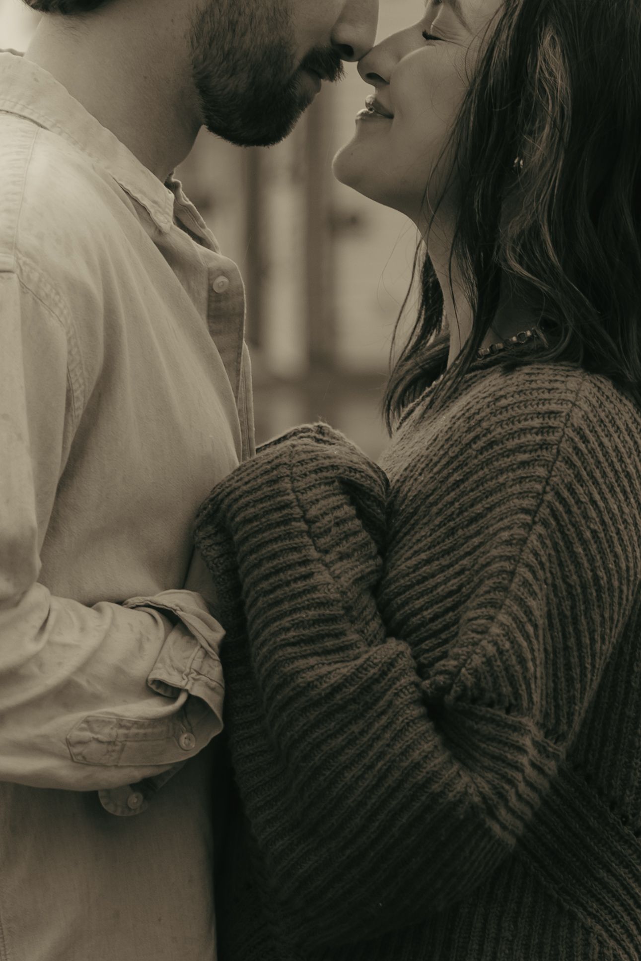 A romantic black and white photo series showing intimate moments between a couple in close embrace.