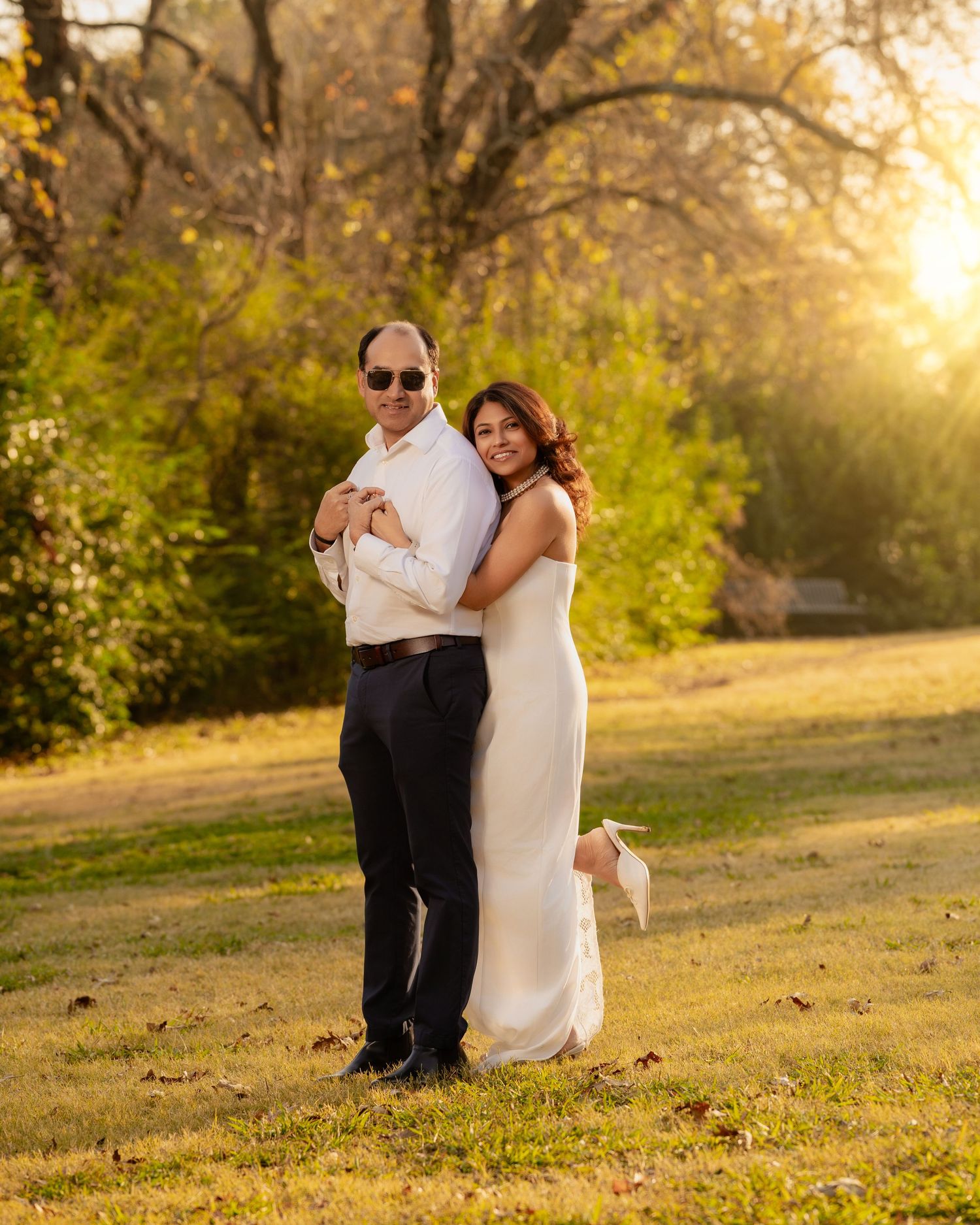 Golden hour couple photography session in a grassy field.