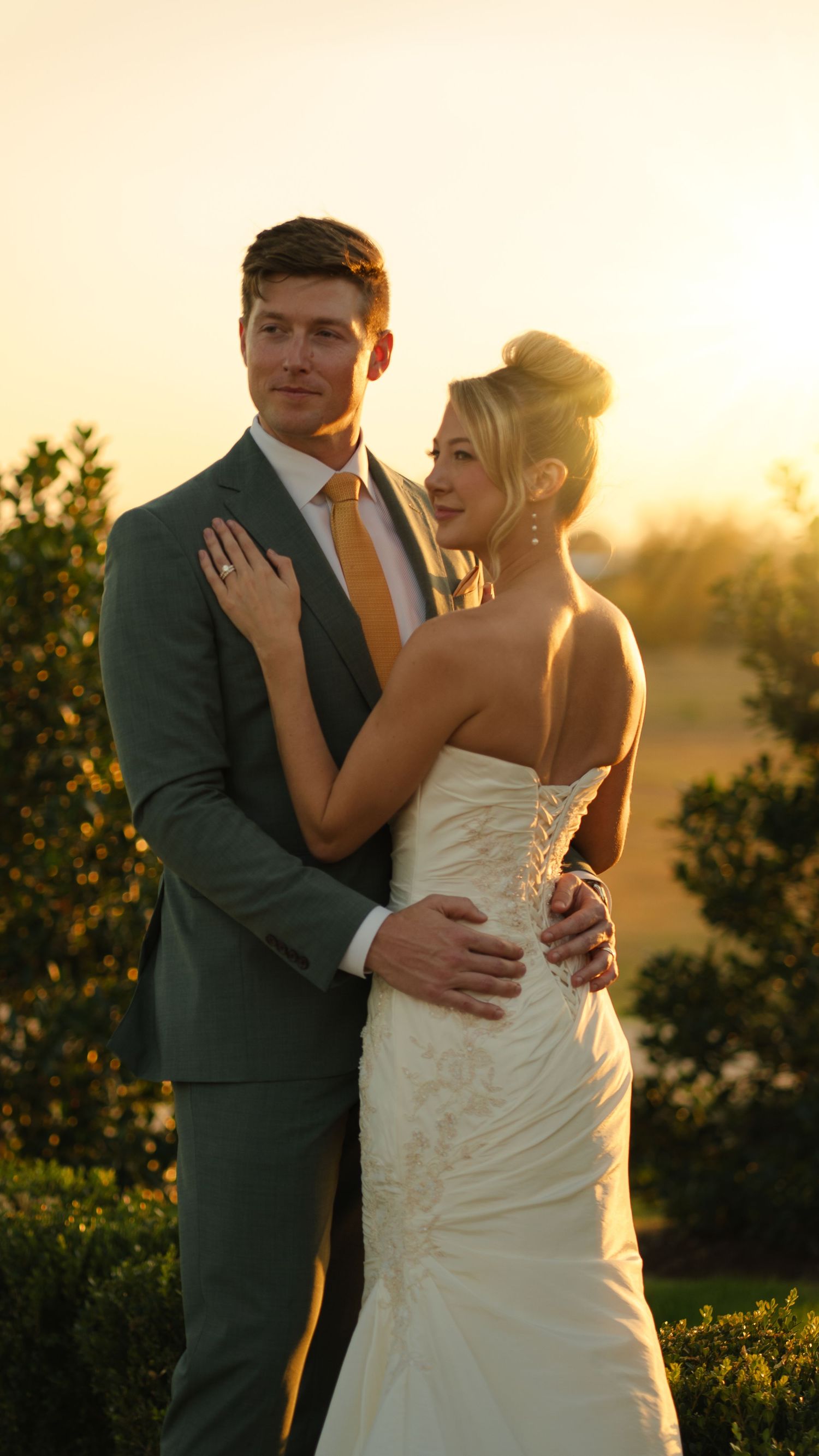 Romantic sunset wedding portraits capturing intimate moments between newlyweds.
