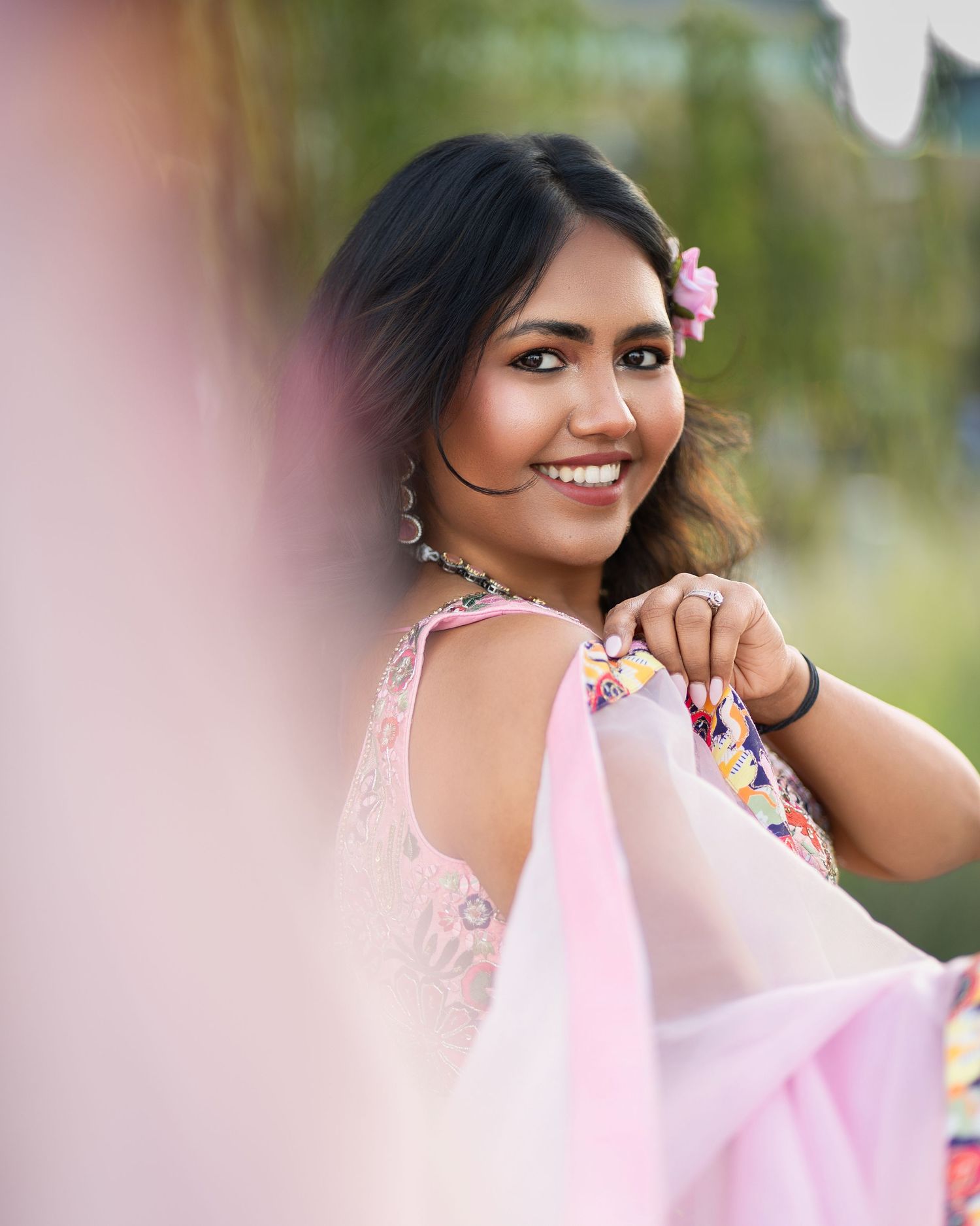 Outdoor portrait series with soft pink lighting and natural bokeh effects.