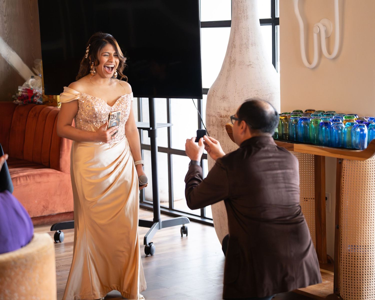 A series of candid moments captured during a wedding reception showing guests and decor in warm lighting.
