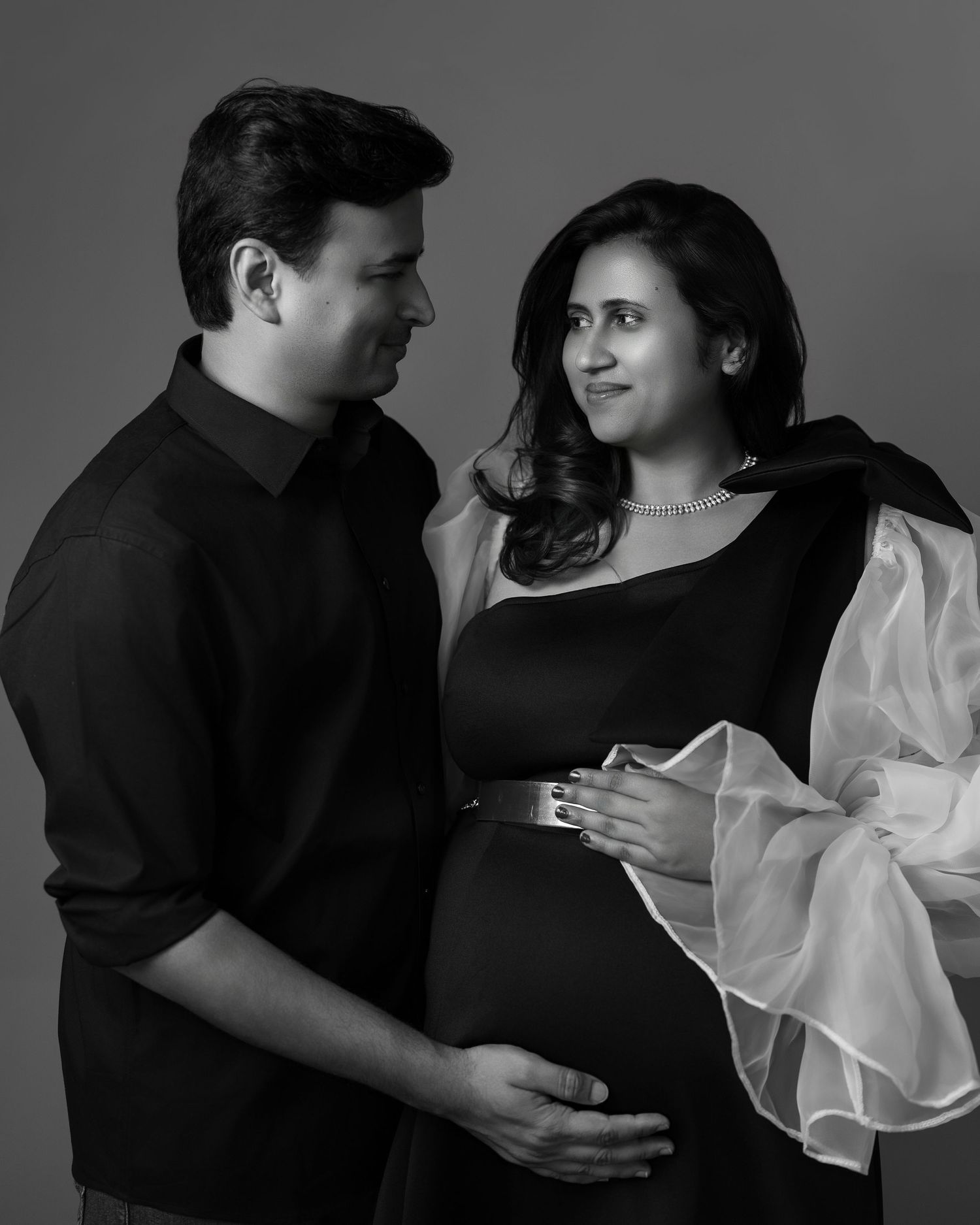 Romantic couple photoshoot in black and white showing intimate moments and tender embraces.