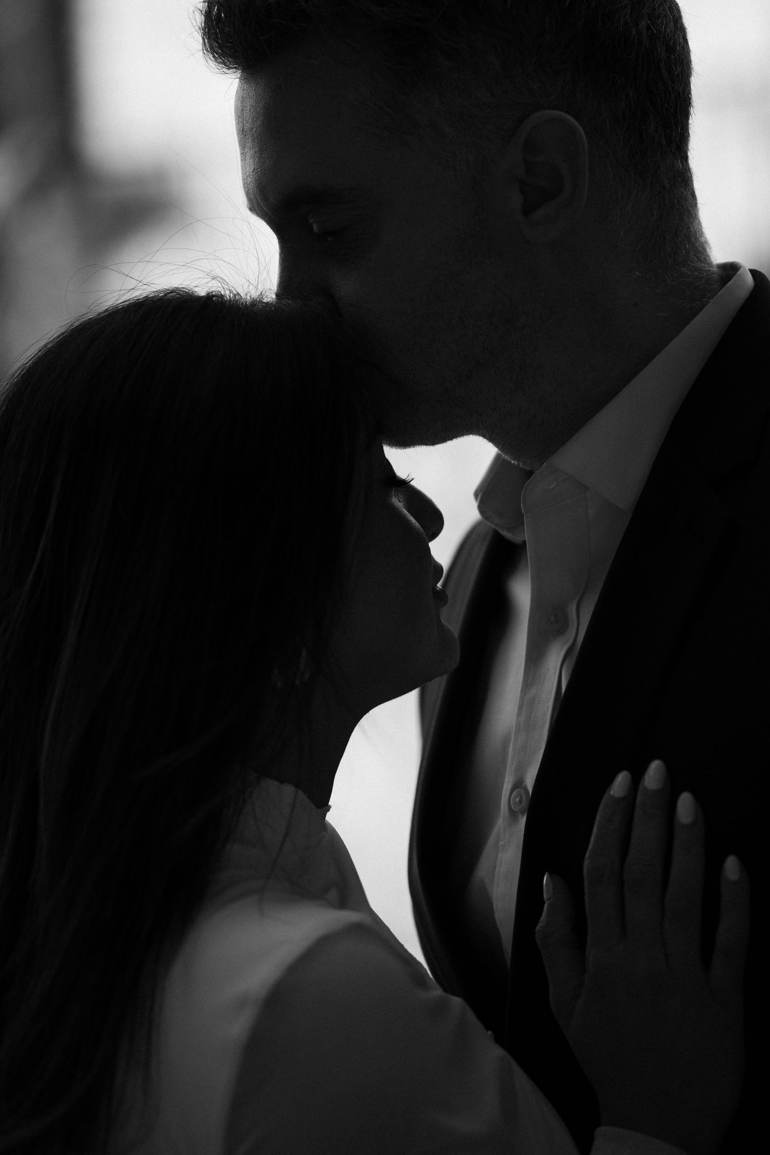 Intimate silhouette portraits capturing romantic moments in black and white.