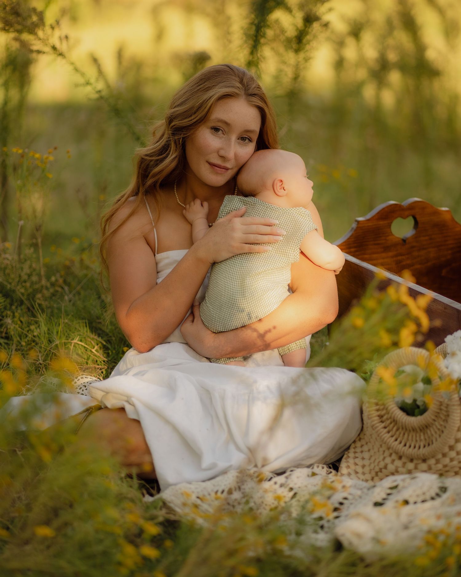 A whimsical outdoor portrait with plush toys and lace details in golden light.