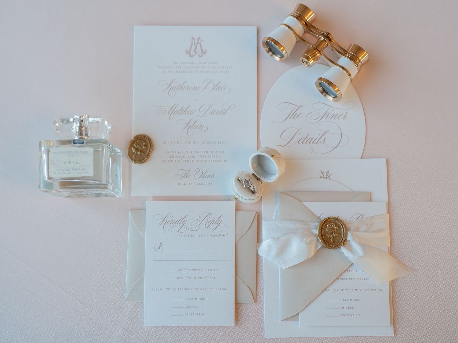 Elegant wedding stationery flat lay with gold wax seals and ribbon details.