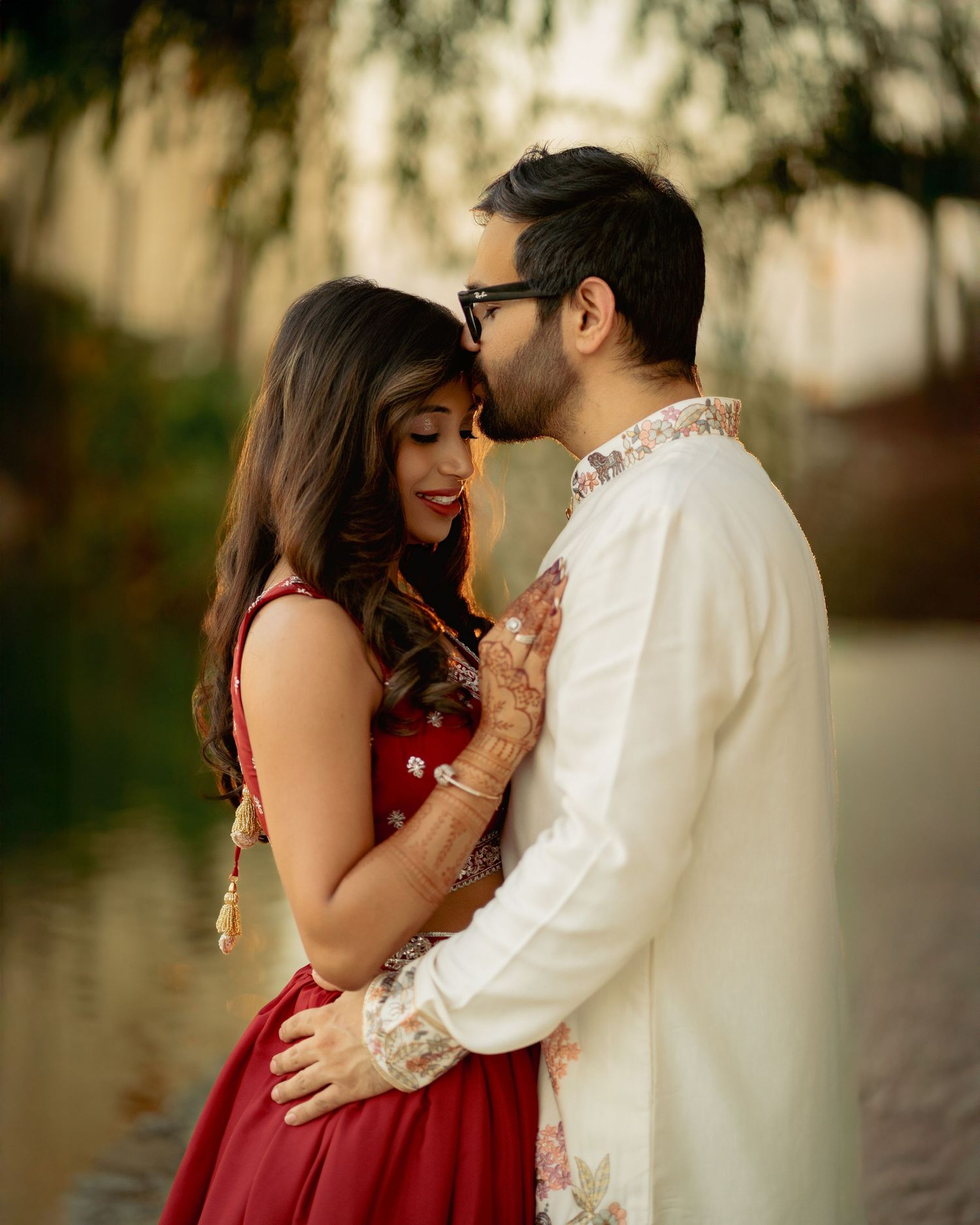 Romantic couple sharing intimate moment during outdoor engagement photoshoot.