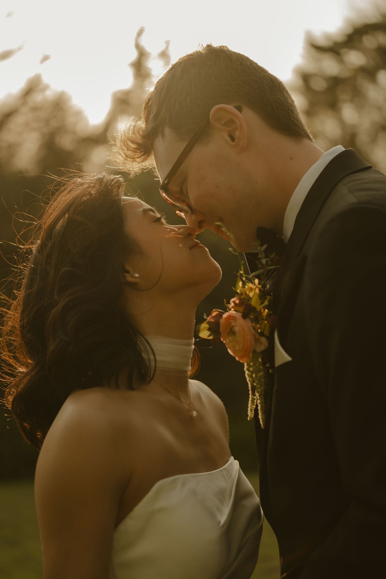 Bride and groom share an intimate moment during golden hour at their outdoor wedding ceremony.