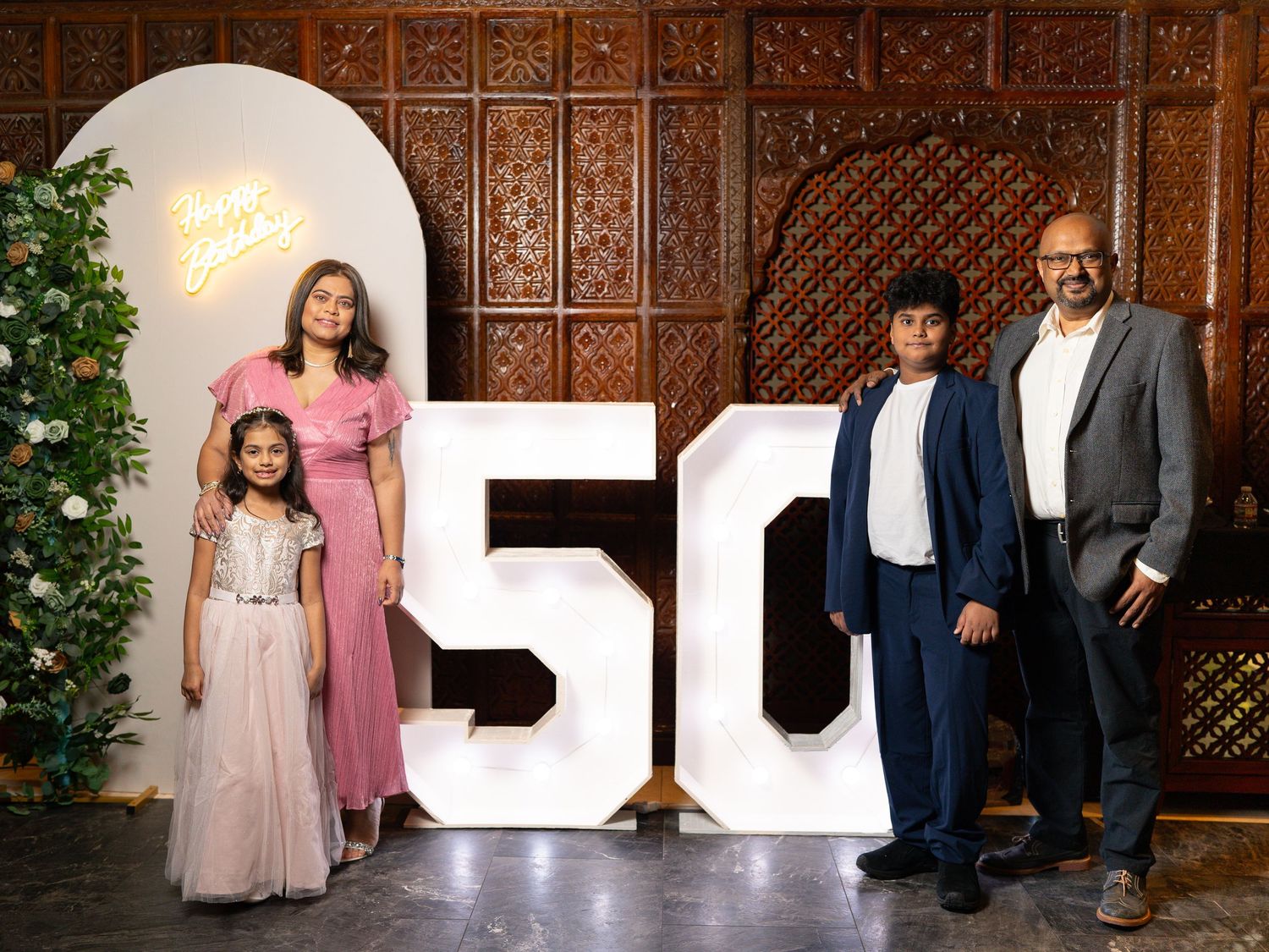A collection of wedding photos showing formal attire and decorative letters against an ornate wooden backdrop.