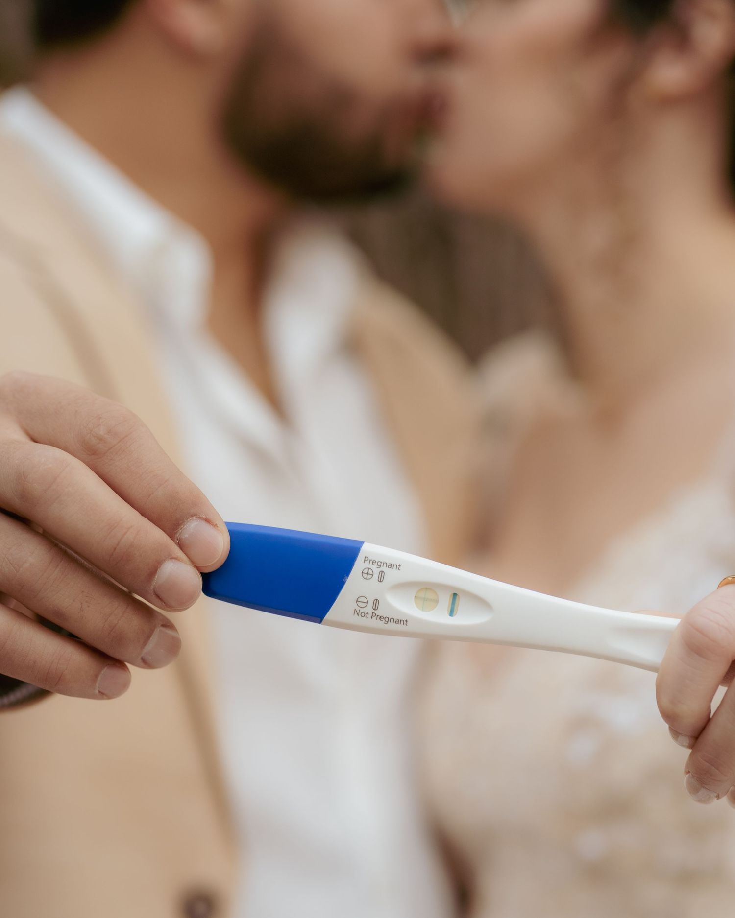 Close-up shots of hands holding pregnancy test showing positive results.