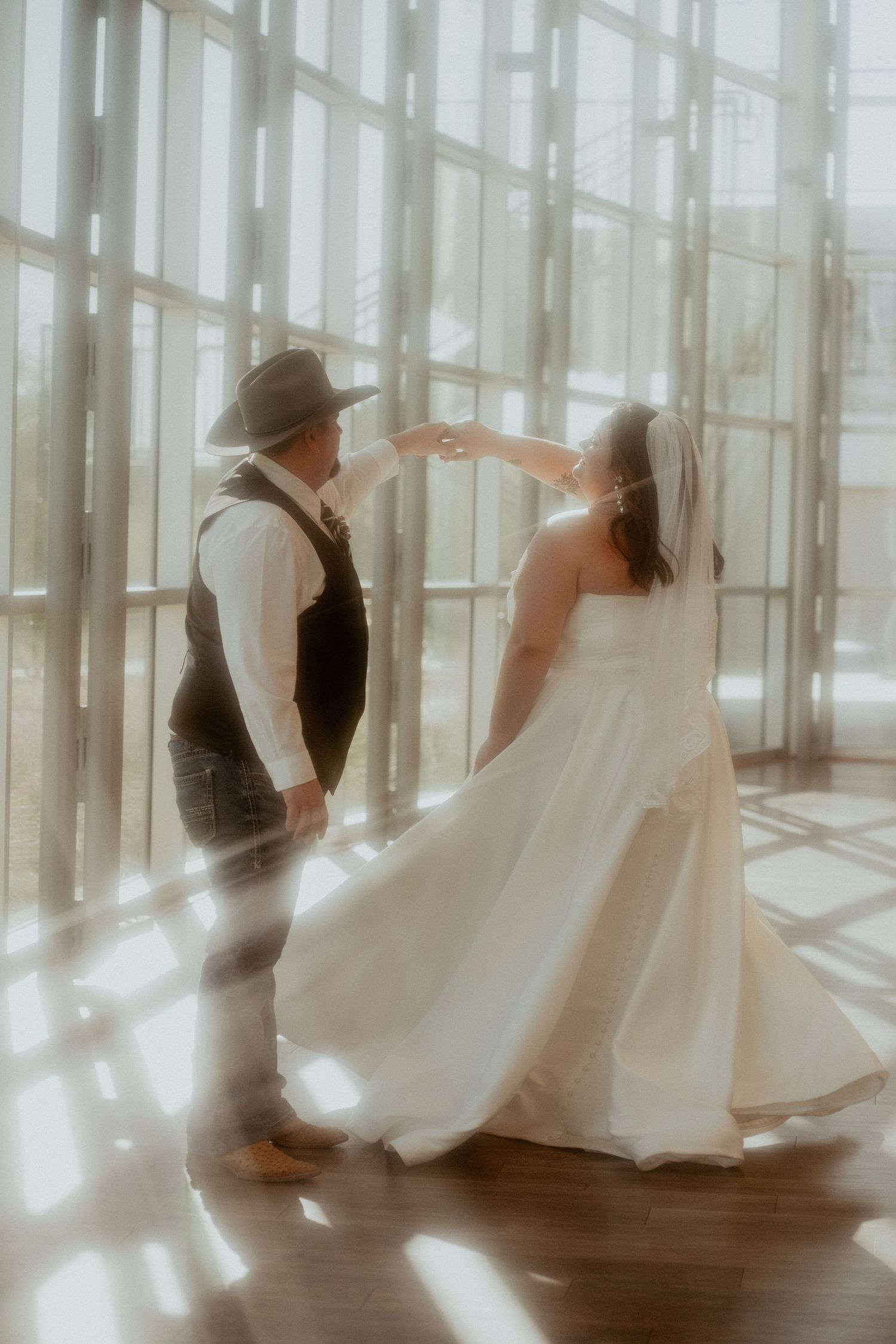 Artistic wedding dance sequence captured through multiple exposure in a sunlit venue with flowing white dress.