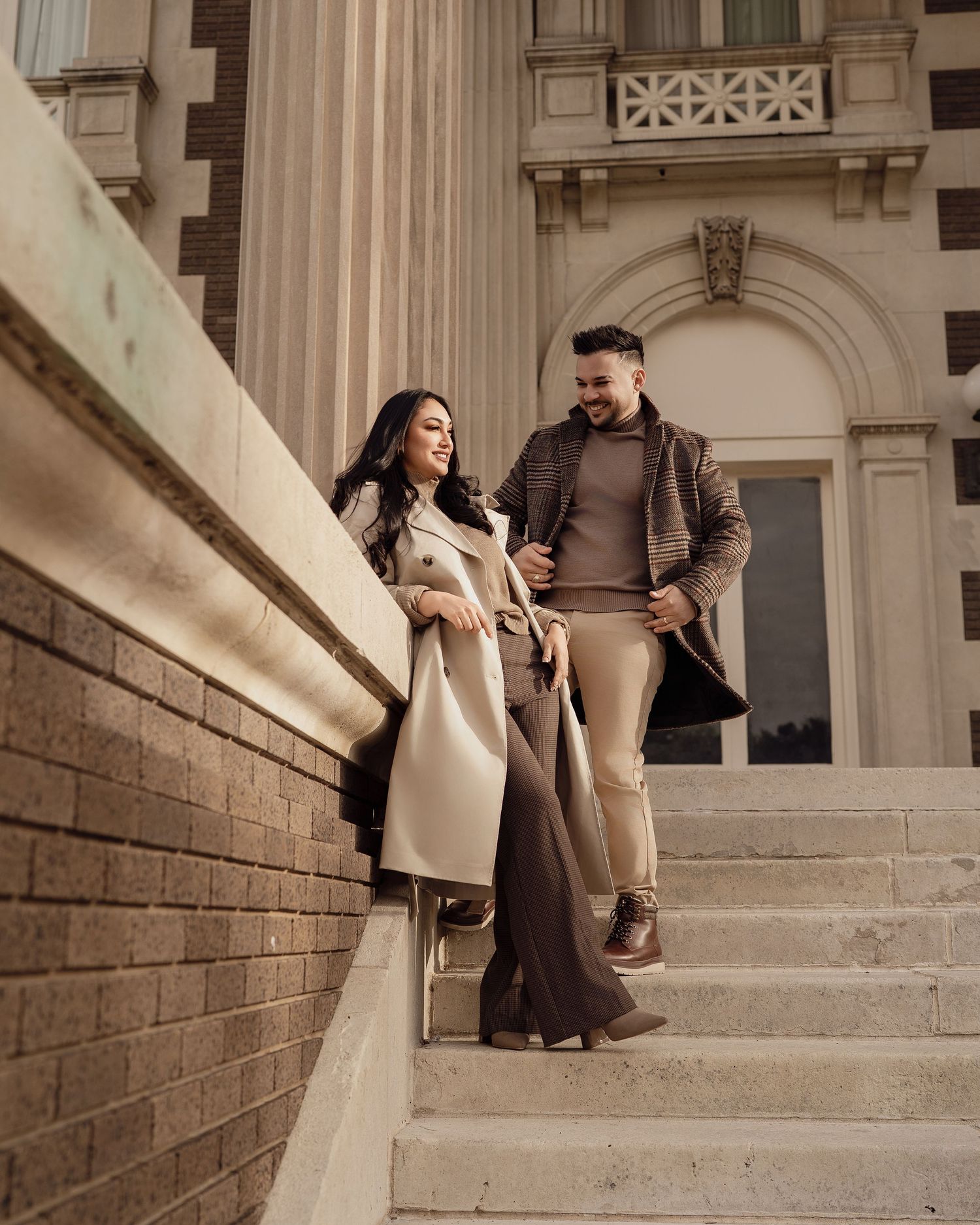 Elegant couple photography session on vintage stone steps with dramatic lighting.
