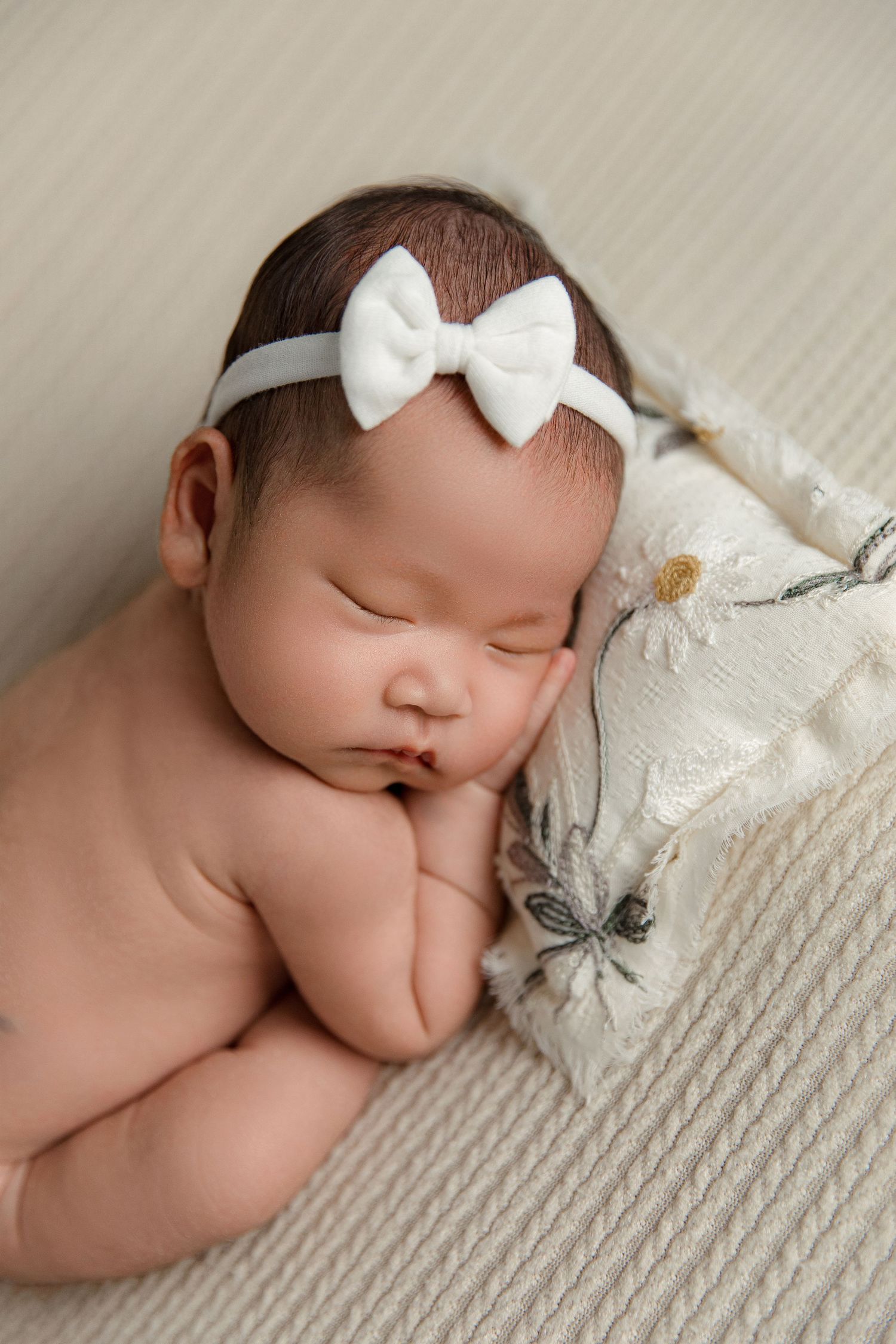 Newborn baby peacefully sleeping during an in-home session in San Jose