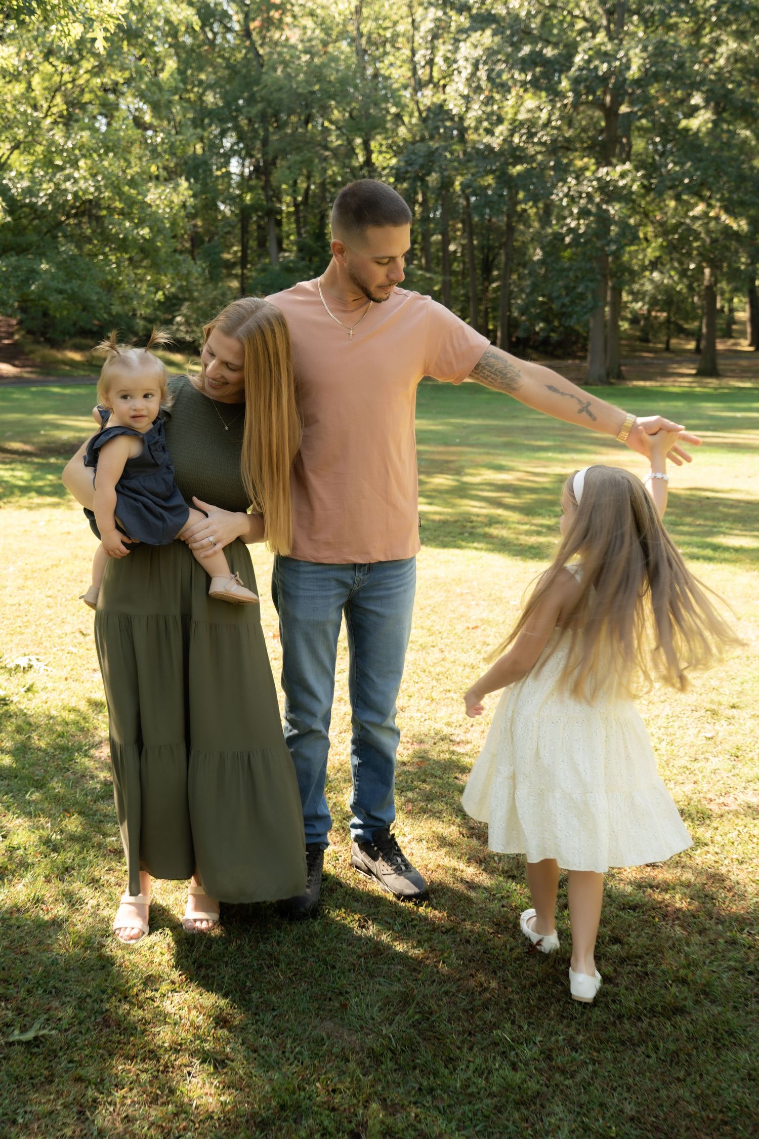 Outdoor family photography session with parents and two kids.