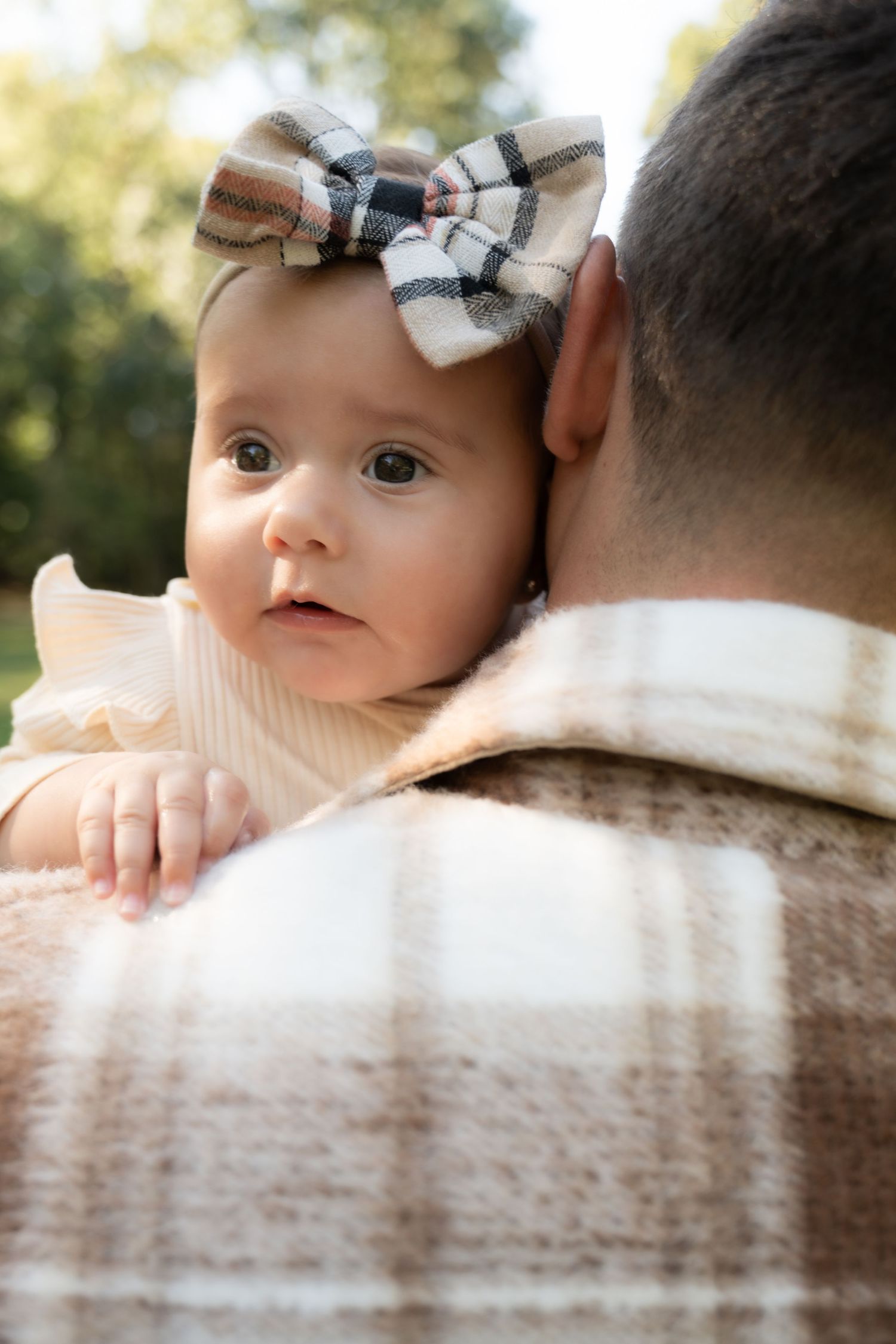Outdoor family session: father and daughter playful interaction