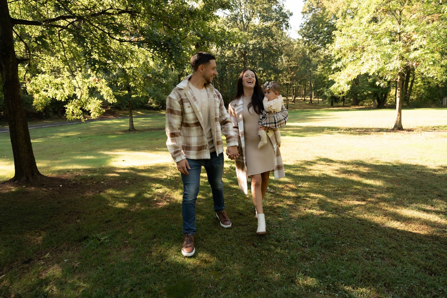 Family of three enjoying relaxed outdoor photo shoot