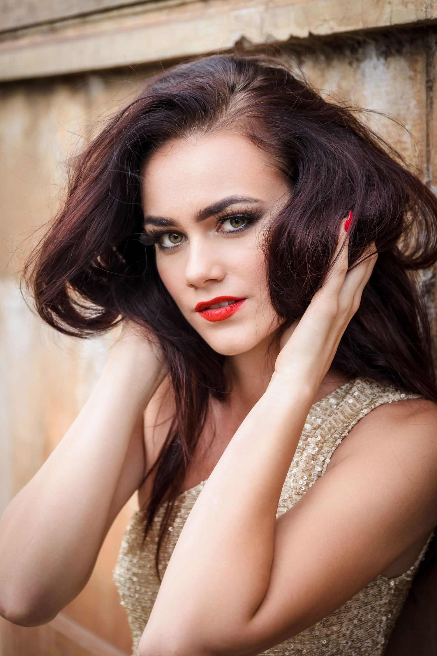 A fashion portrait series showing dramatic poses with dark hair, red lipstick, and a sequined top against a neutral backdrop.