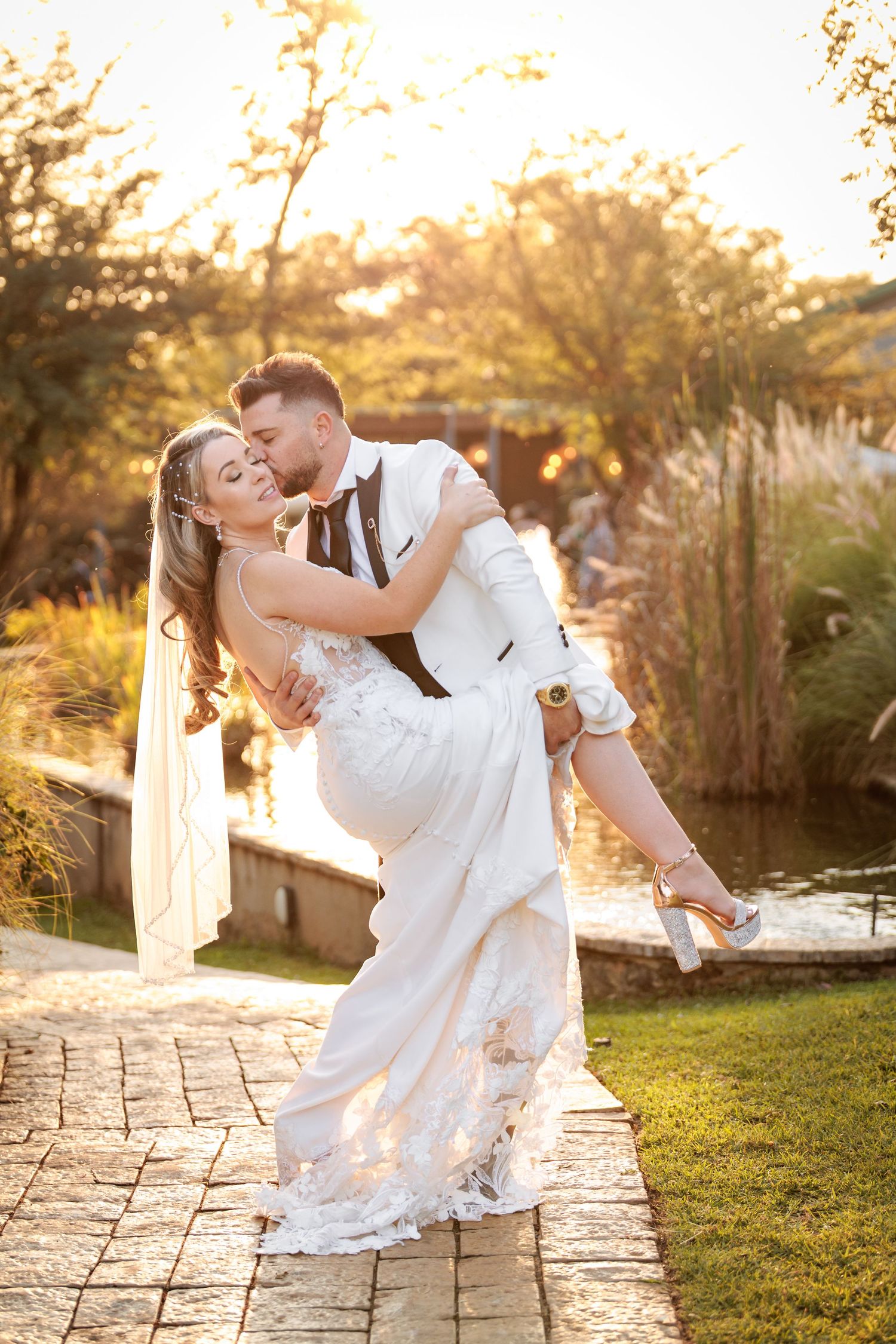 Romantic sunset dance dip sequence captured on stone patio with golden light filtering through trees.
