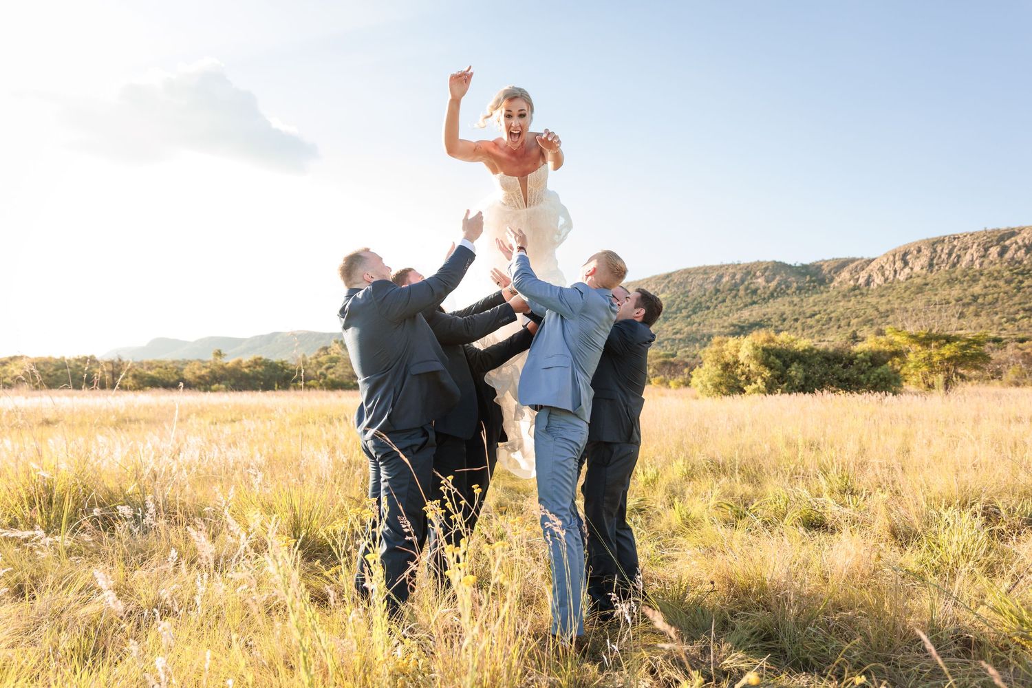 A series of six photos showing people embracing in a golden field during sunset with desert mountains in the background.