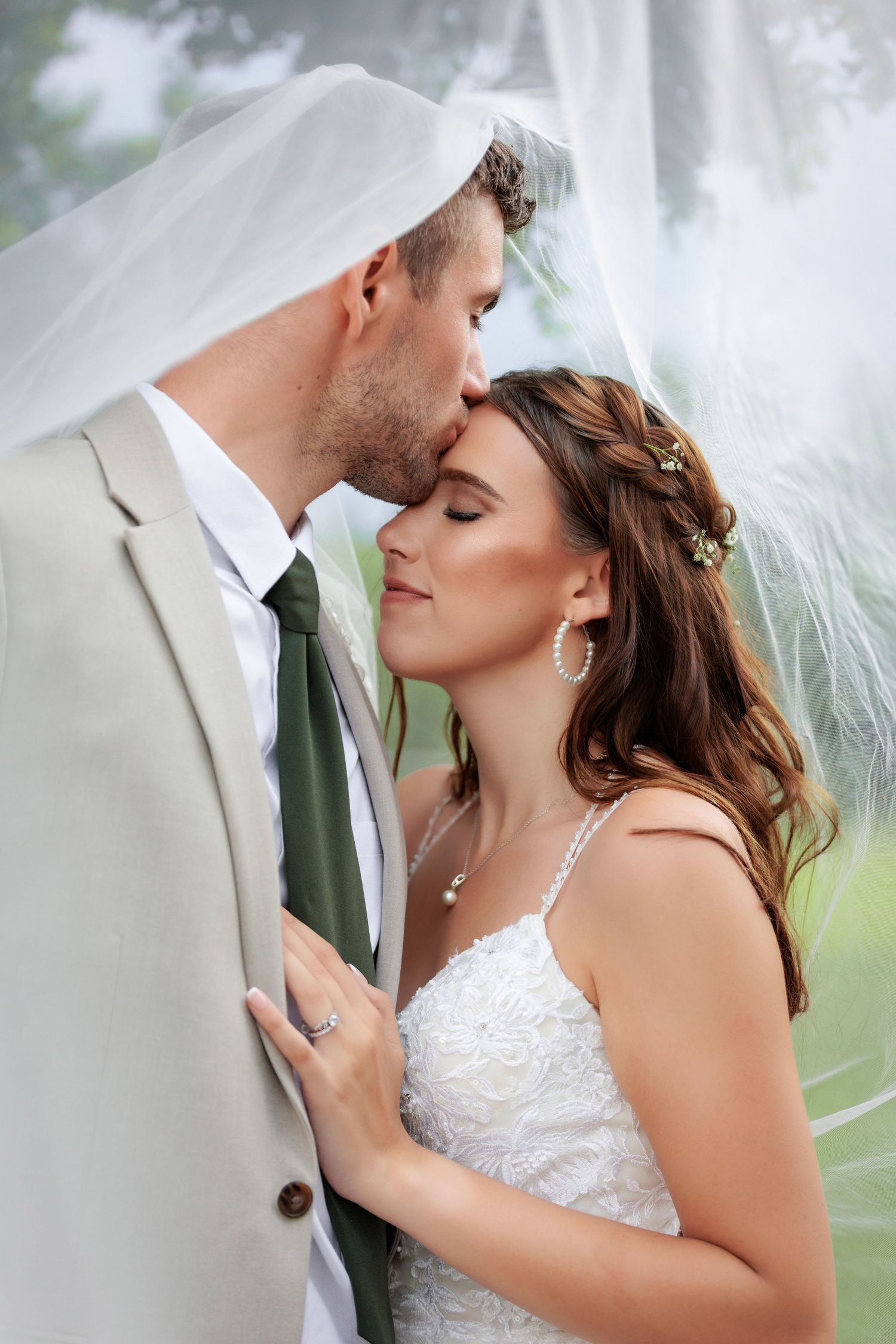 Intimate wedding portrait with soft lighting and delicate veil details.