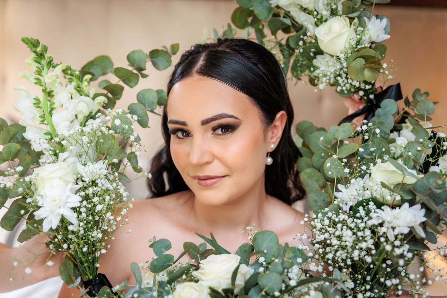 Bridal portraits with lush white and green floral arrangements.