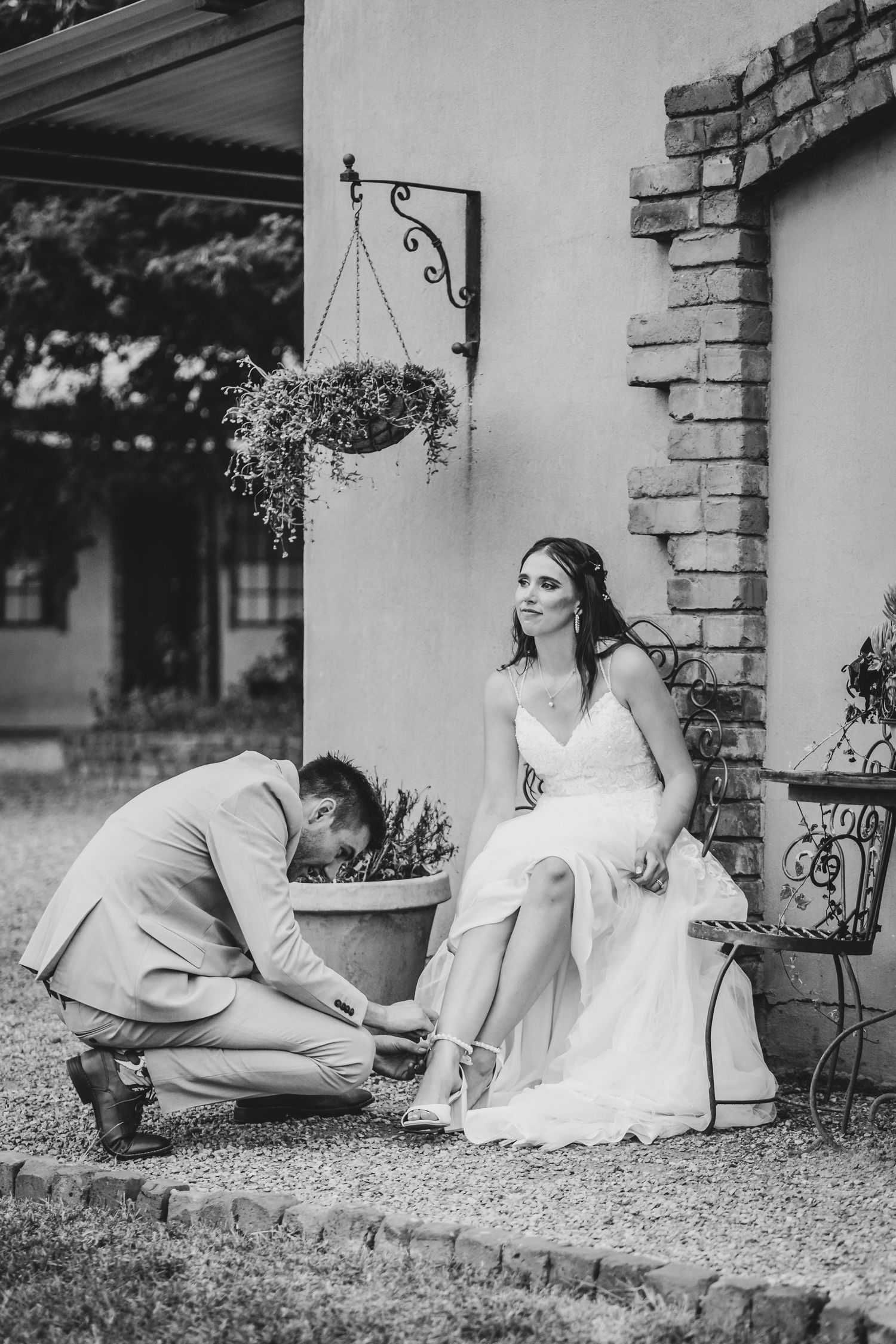 Black and white series of wedding moments on a rustic brick porch.