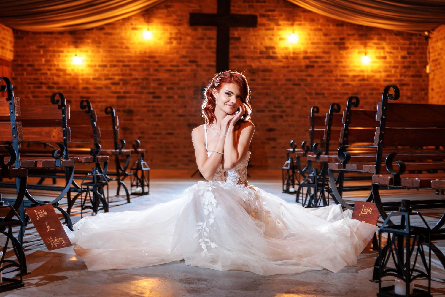 A romantic dance moment captured in a warmly lit brick chapel setting.