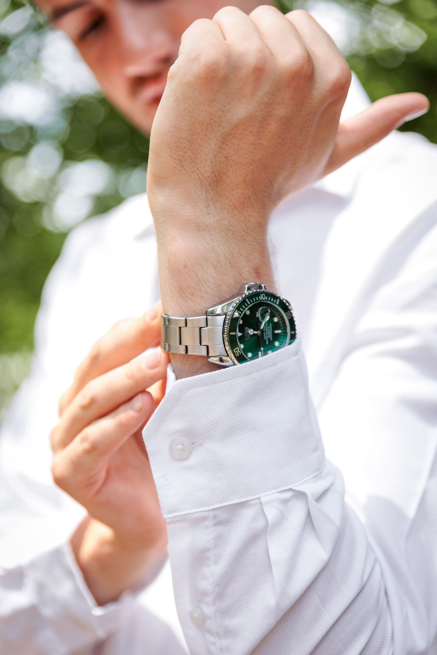 Multiple shots of someone wearing a white dress shirt and metallic watch.