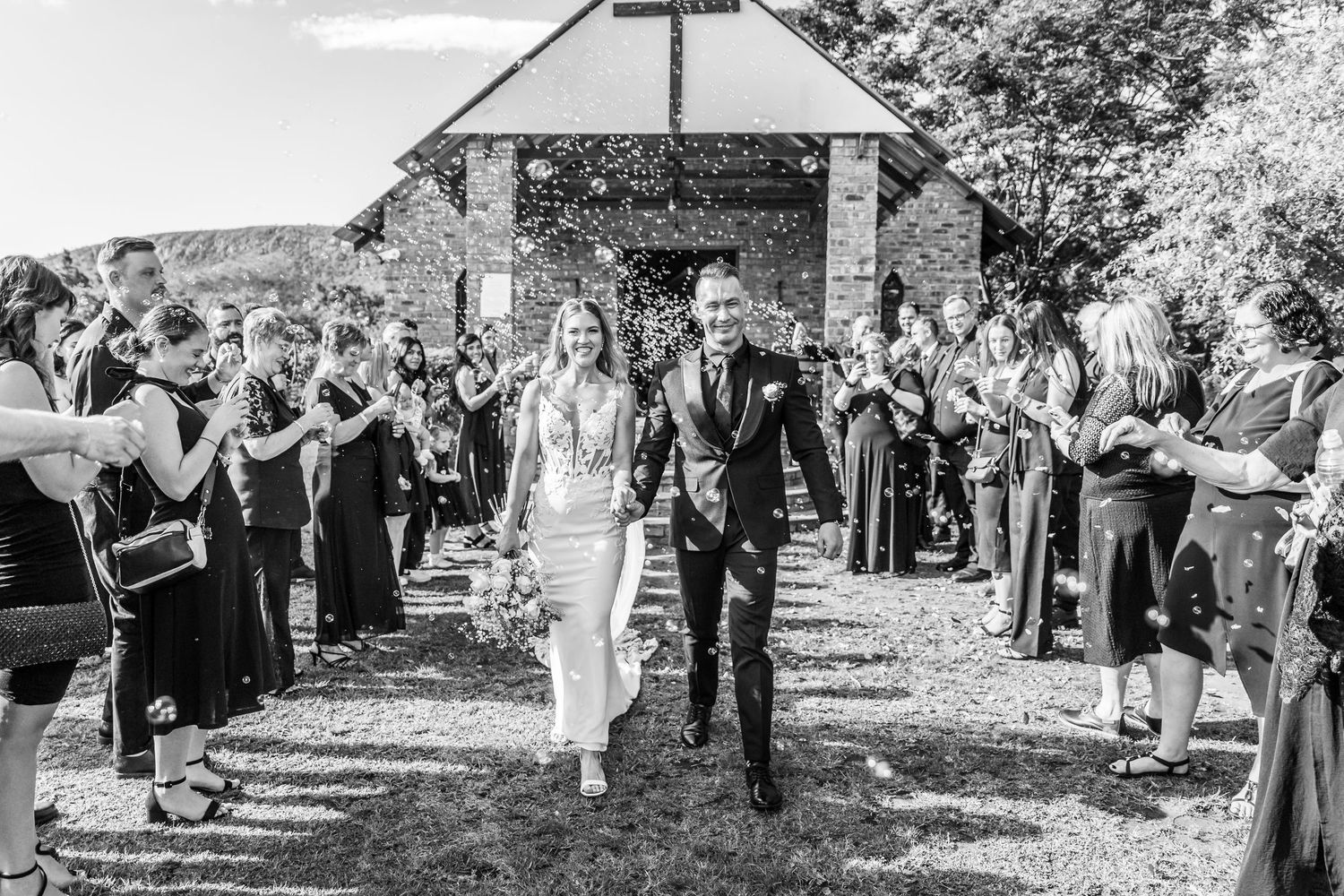A series of black and white photographs showing wedding celebrations in an outdoor garden setting.