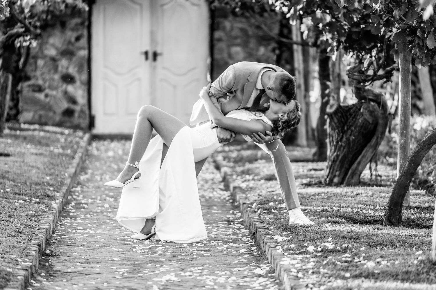 A dramatic black and white dip pose captured during wedding portraits.