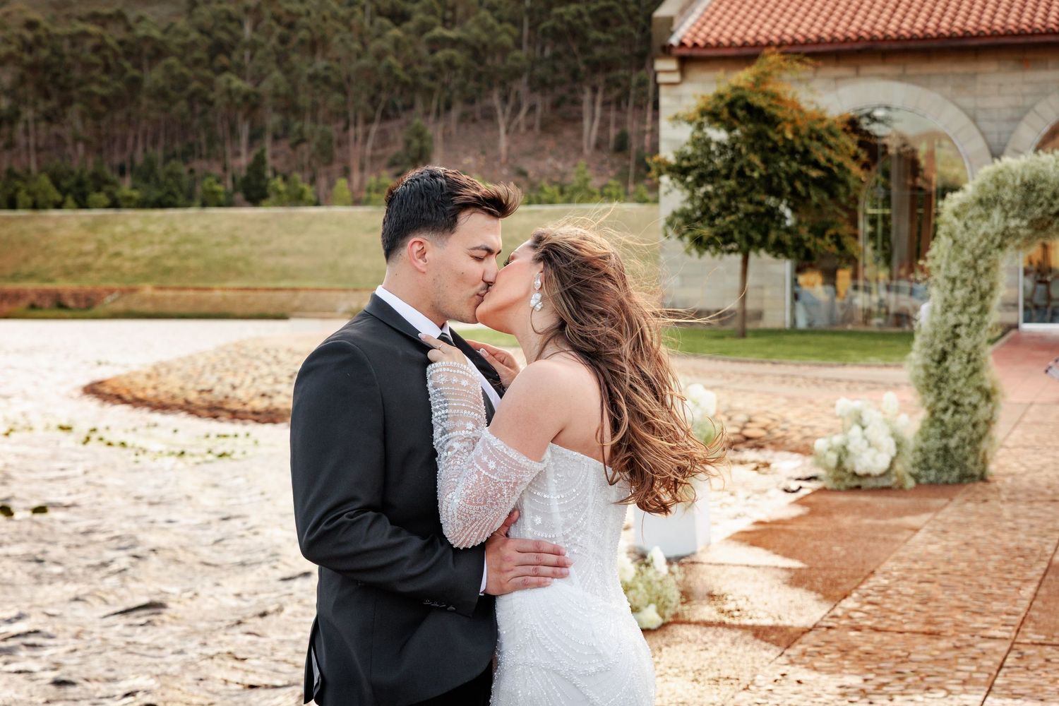 Romantic couple shares tender moments in formal attire during outdoor photo session at multiple scenic locations.