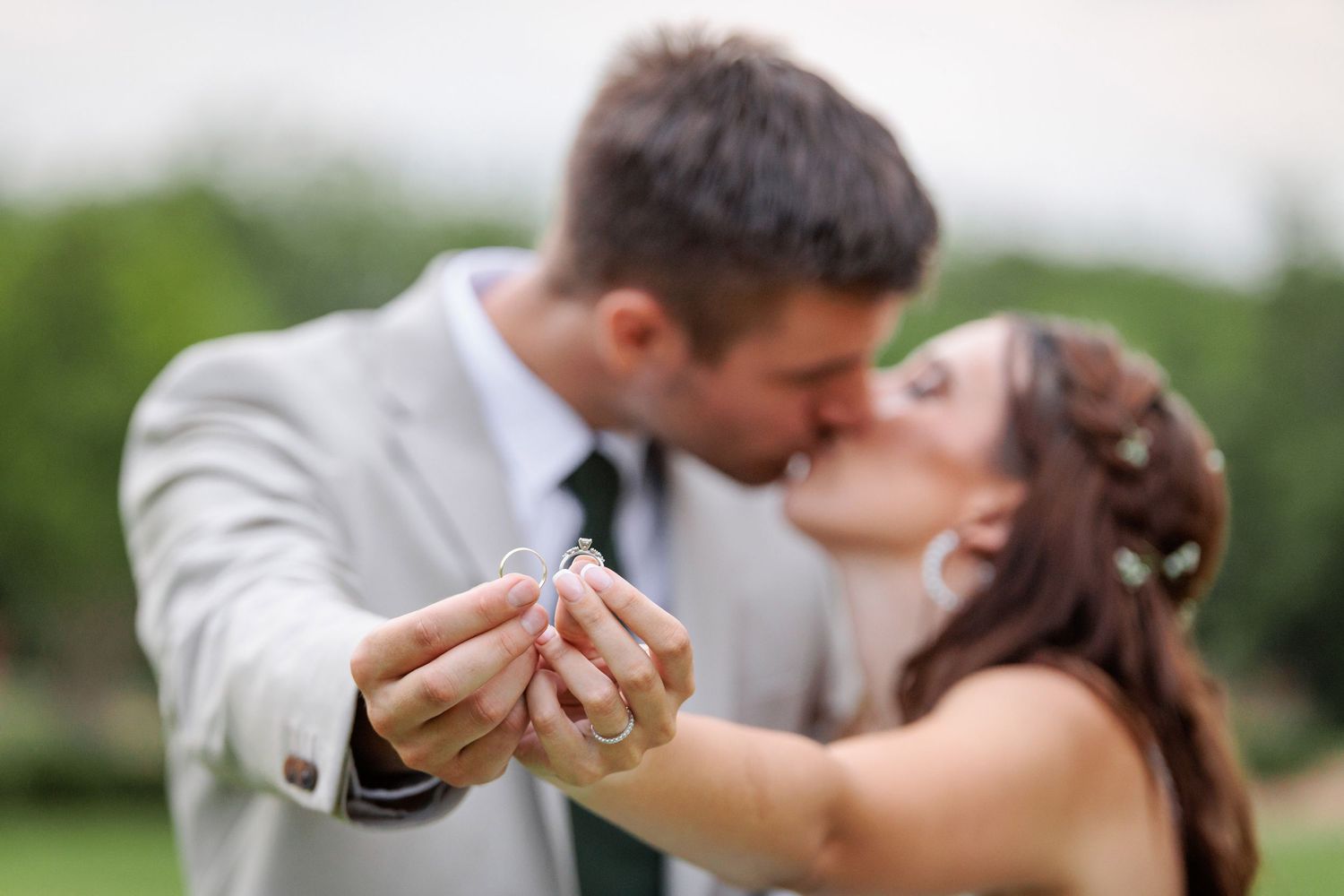 A tender wedding moment captured during an outdoor celebration.