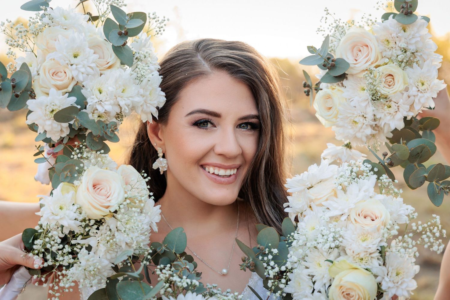 Wedding floral arrangement with white roses and eucalyptus leaves.