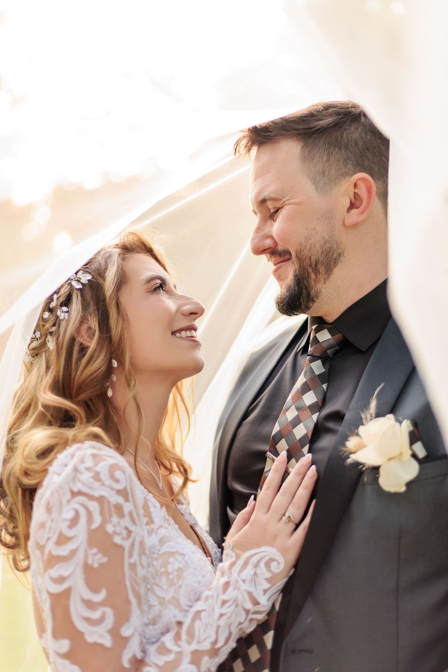 A romantic wedding moment captured outdoors with the couple sharing a tender look in beautiful natural lighting.