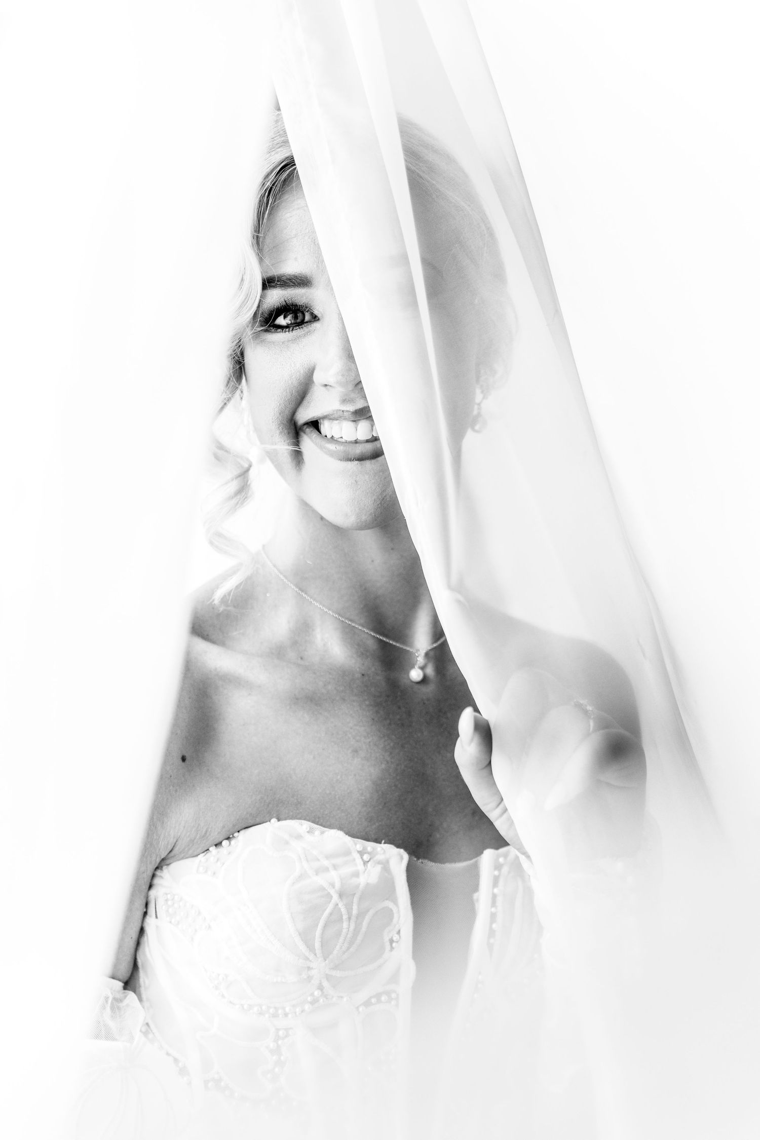 A series of ethereal black and white portraits showing a figure veiled in soft white fabric creating a dreamy effect.