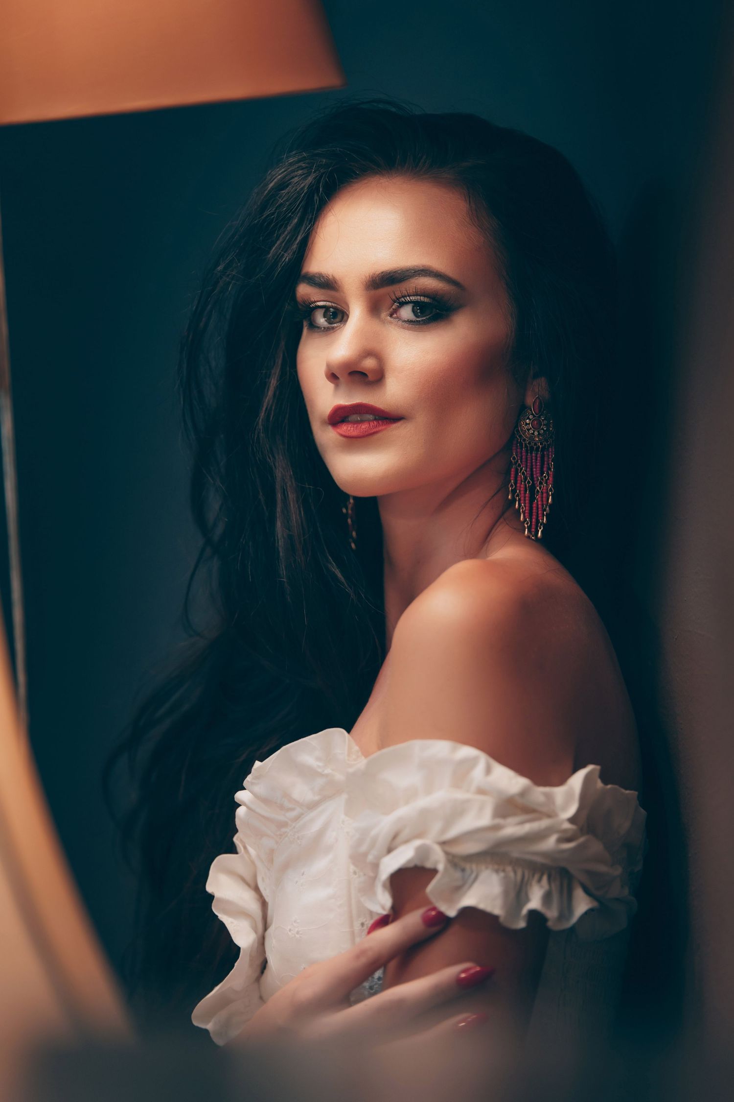 Artistic portrait series featuring dramatic lighting and a white ruffled collar against a dark background.